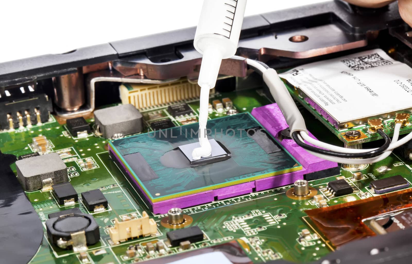 Thermal compound in syringe and laptop video chip by RawGroup
