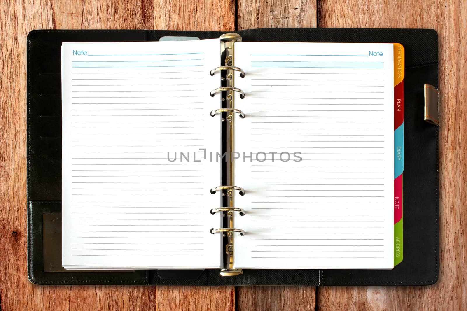 leather open notebook on old wooden background