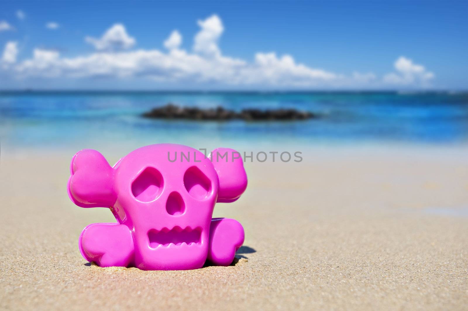 Pink toy on the beach showing danger by tish1