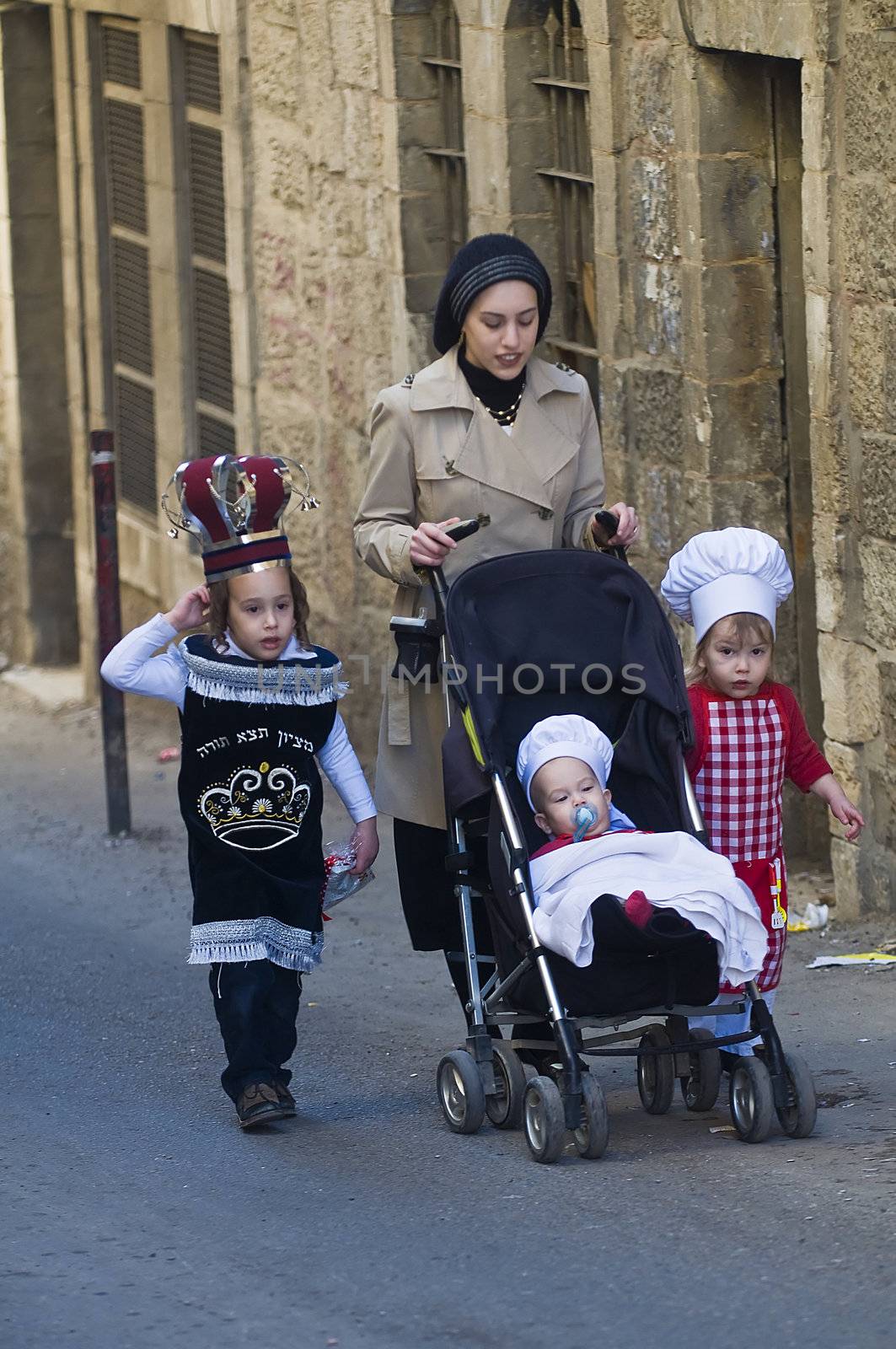 JERUSALEM - MARS 08 : Ultra Orthodox family during Purim in Mea Shearim Jerusalem on Mars 09 2012 , Purim is a Jewish holiday celebrates the salvation of the jews from jenocide in ancient Persia
