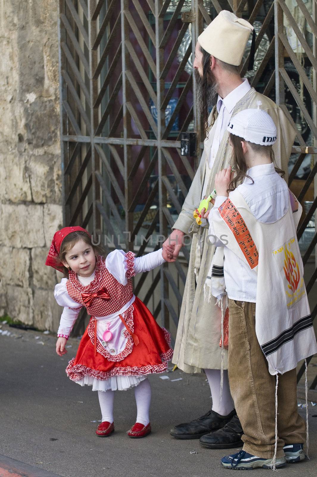 JERUSALEM - MARS 08 : Ultra Orthodox family during Purim in Mea Shearim Jerusalem on Mars 09 2012 , Purim is a Jewish holiday celebrates the salvation of the jews from jenocide in ancient Persia
