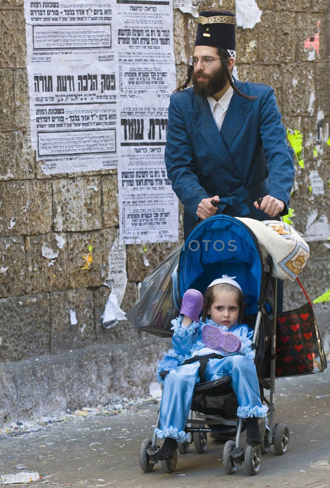 JERUSALEM - MARS 08 : Ultra Orthodox family during Purim in Mea Shearim Jerusalem on Mars 09 2012 , Purim is a Jewish holiday celebrates the salvation of the jews from jenocide in ancient Persia

