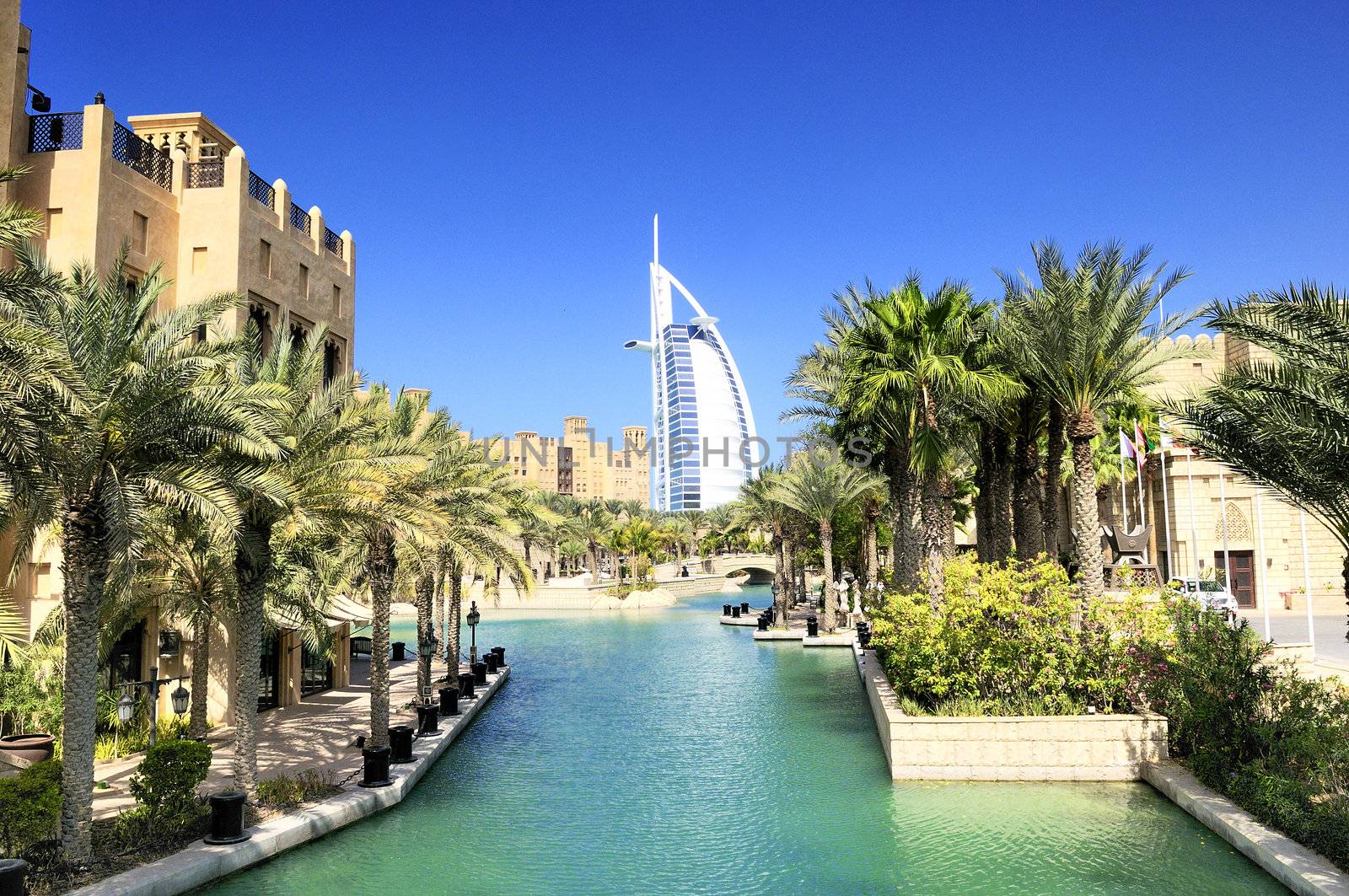 View at hotel Burj al Arab from Madinat Jumeirah in Dubai. Madinat Jumeirah encompasses two hotels and clusters of 29 traditional Arabic houses. United Arabe Emirates