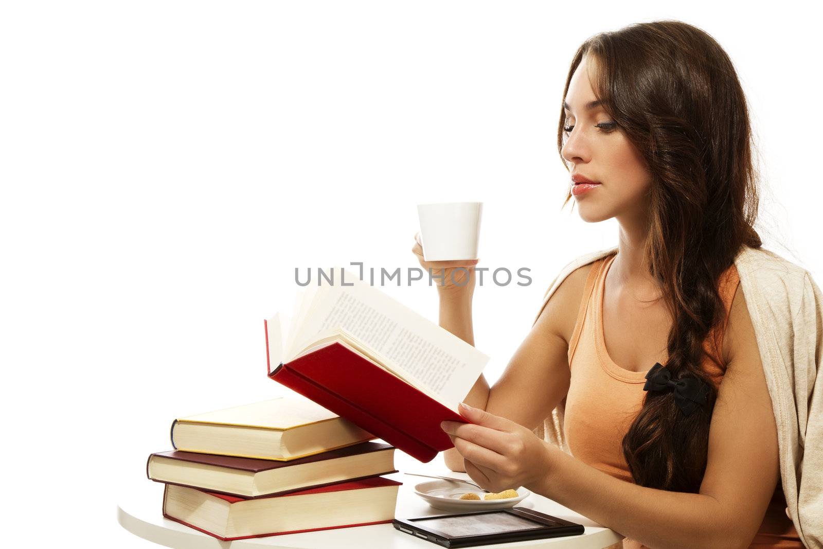 beautiful woman drinking coffee while reading book on white background