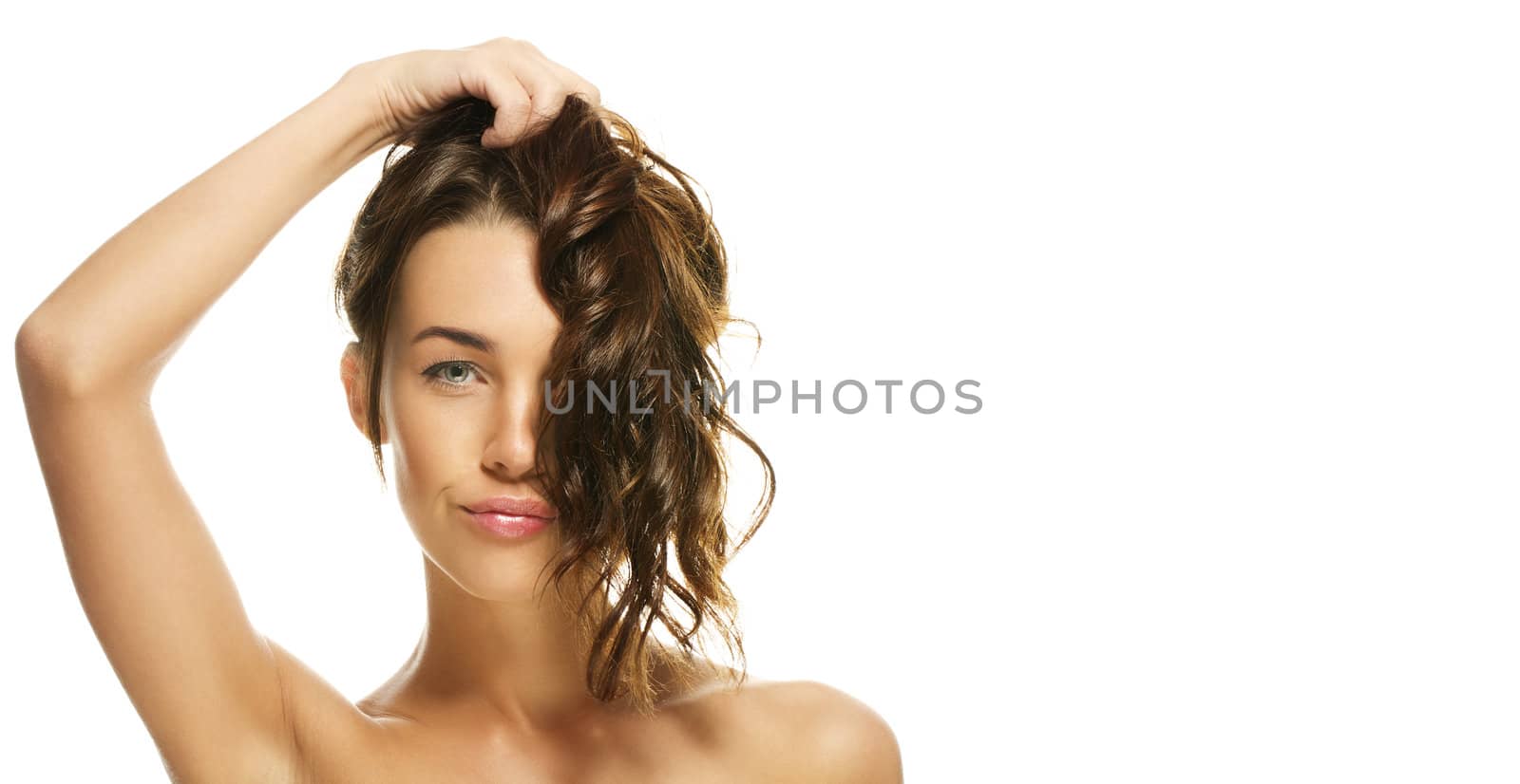 portrait of a beautiful woman holding her hair on white background