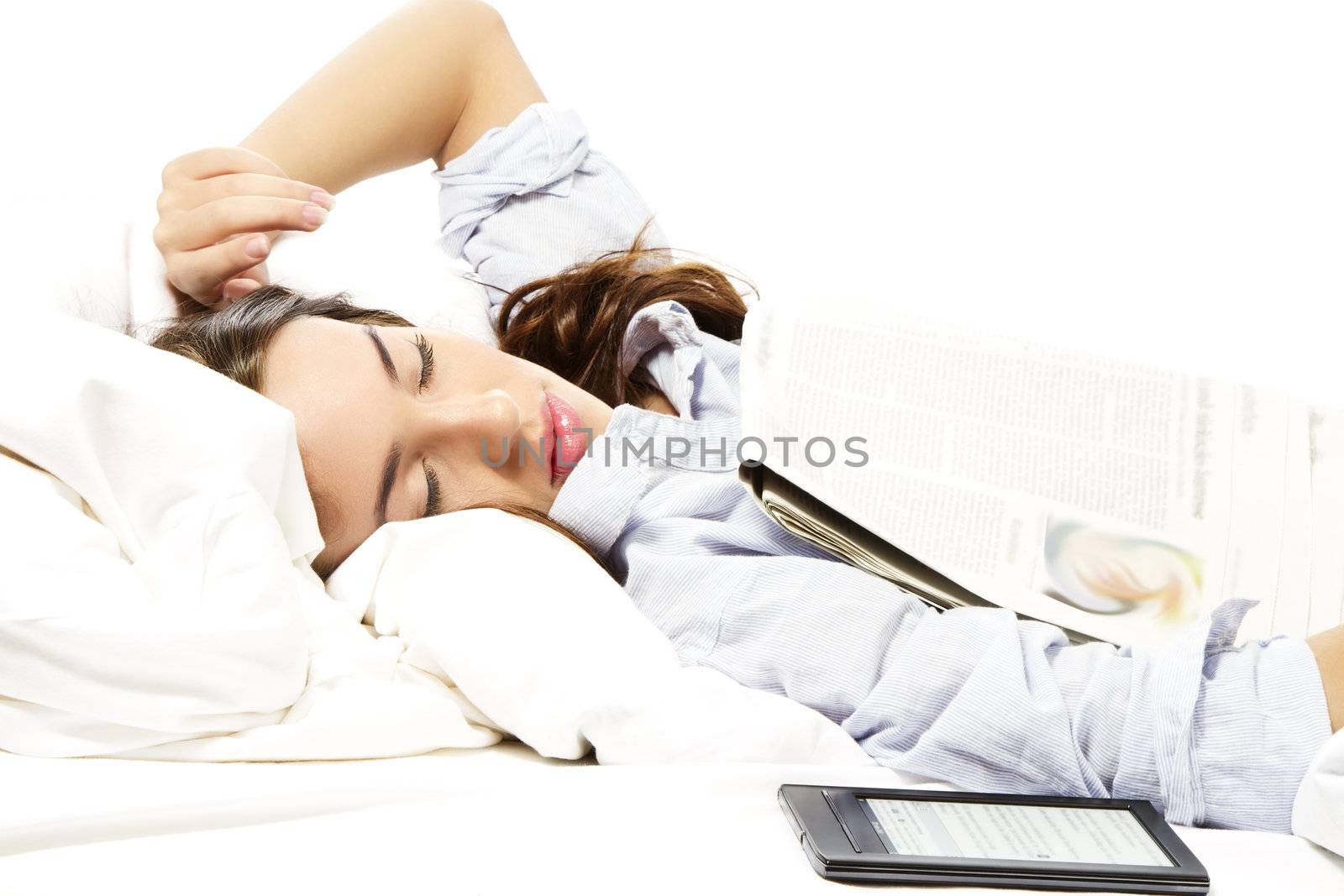 woman felt asleep under a newspaper with ebook reader aside on white background