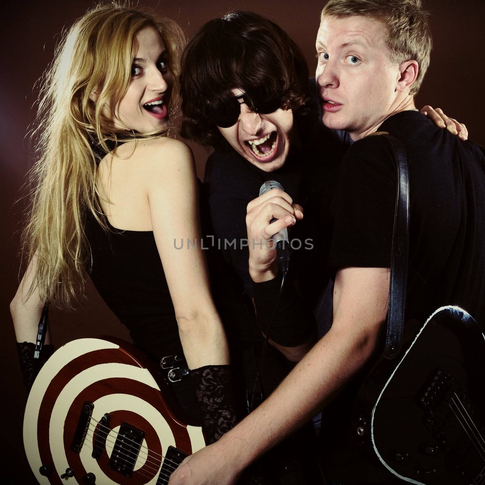 Funny singer and rock band in photostudio