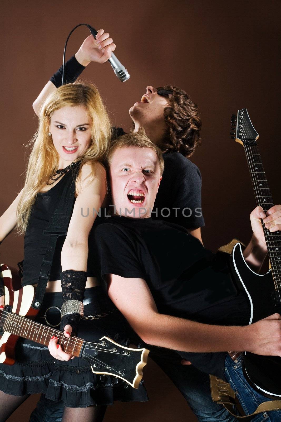 Funny rock band playing in photostudio