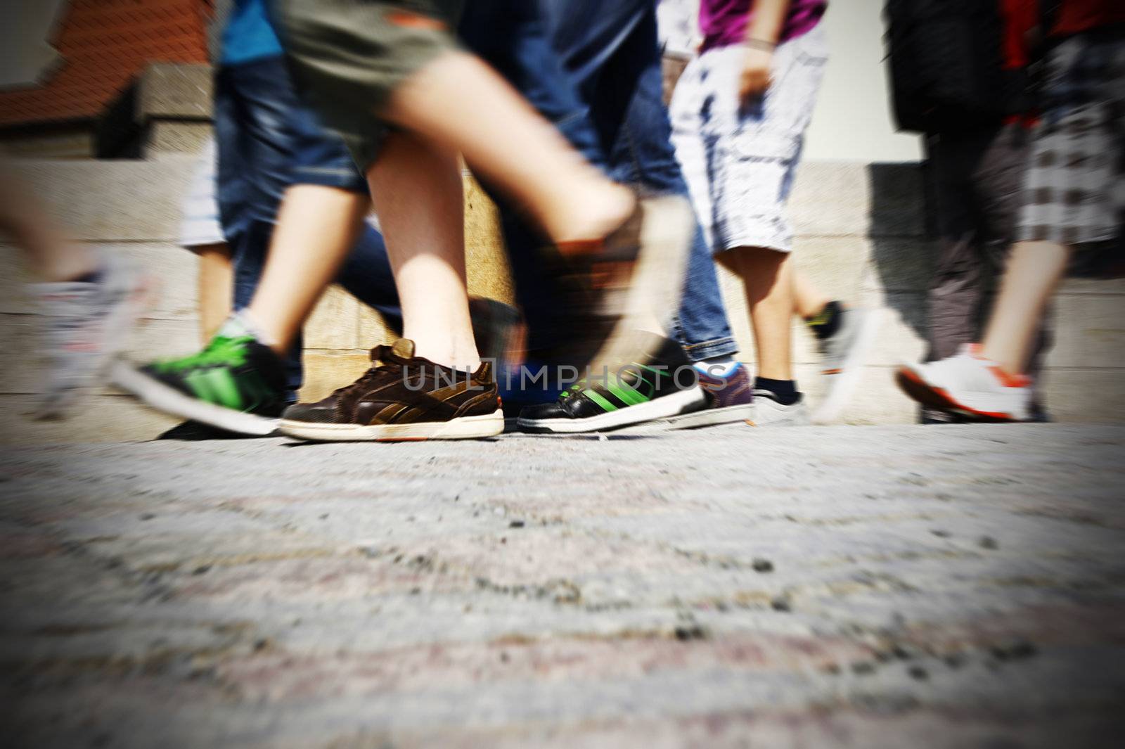  People legs walking on paved urban street