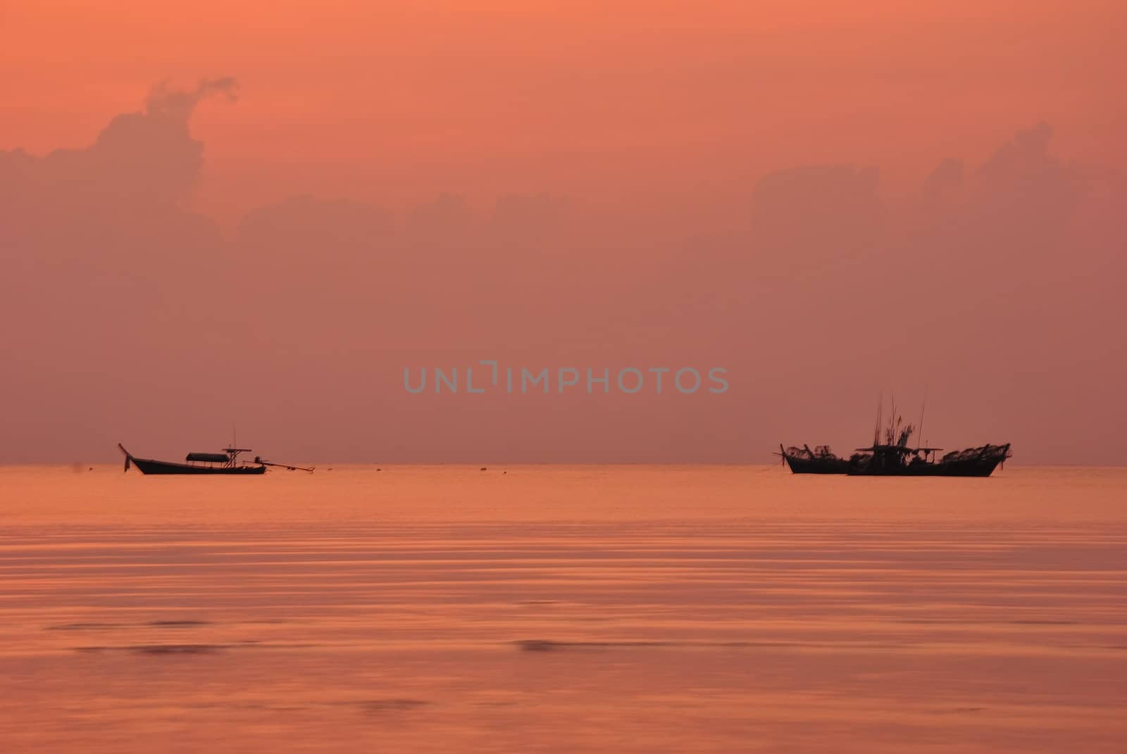 Silhouette fishing boat in the morning at Surin island national park in Thailand