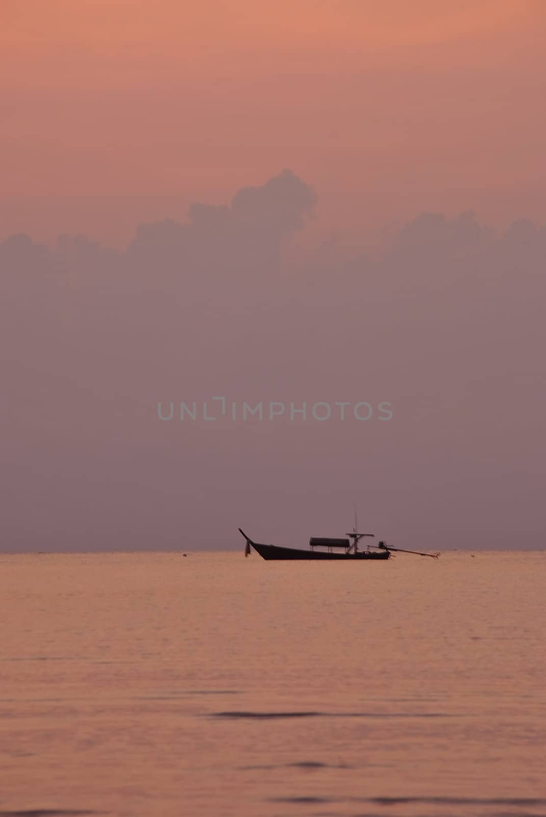 Silhouette fishing boat in the morning at Surin island national park in Thailand