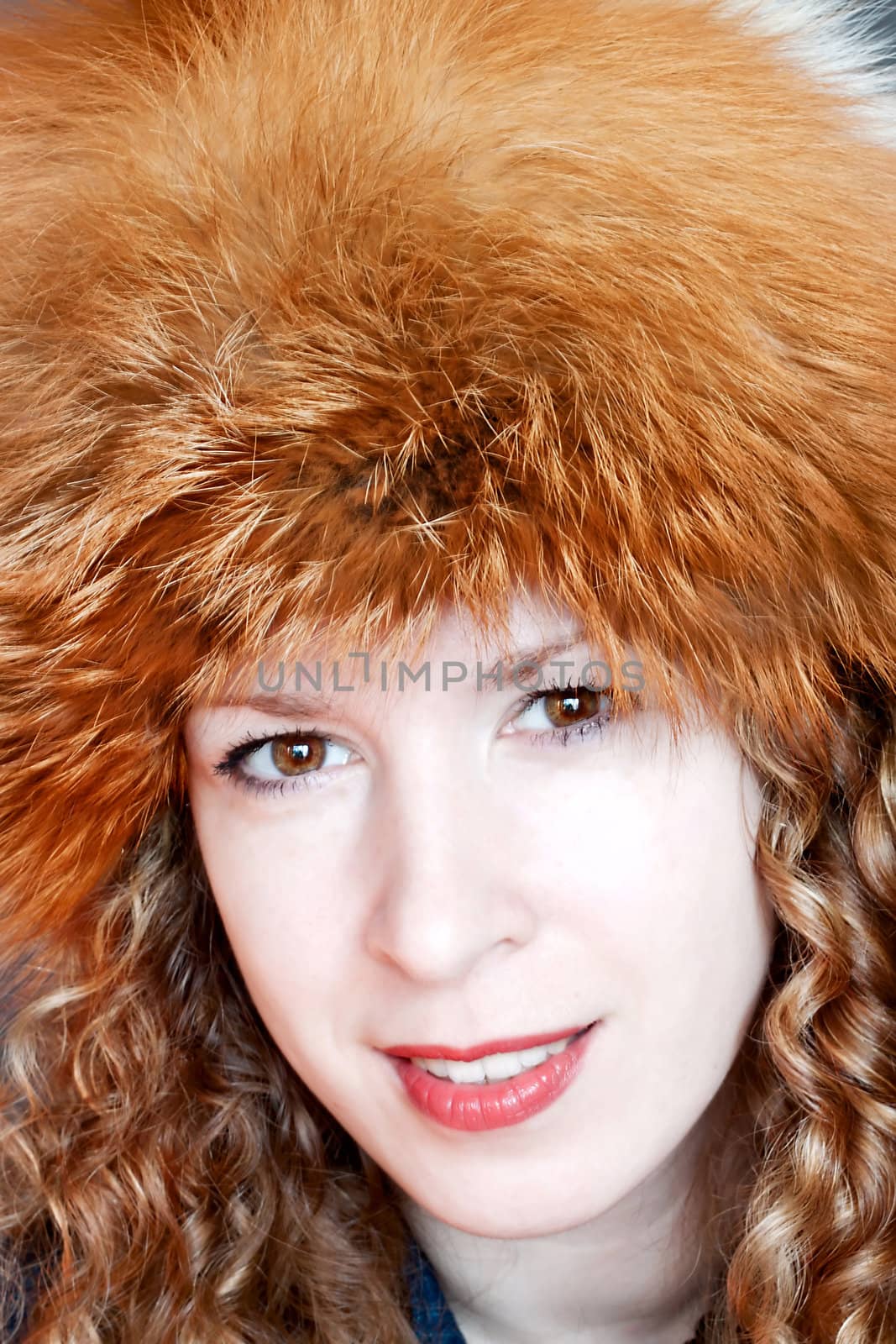 Beautiful young woman posing in big russian style fur hat