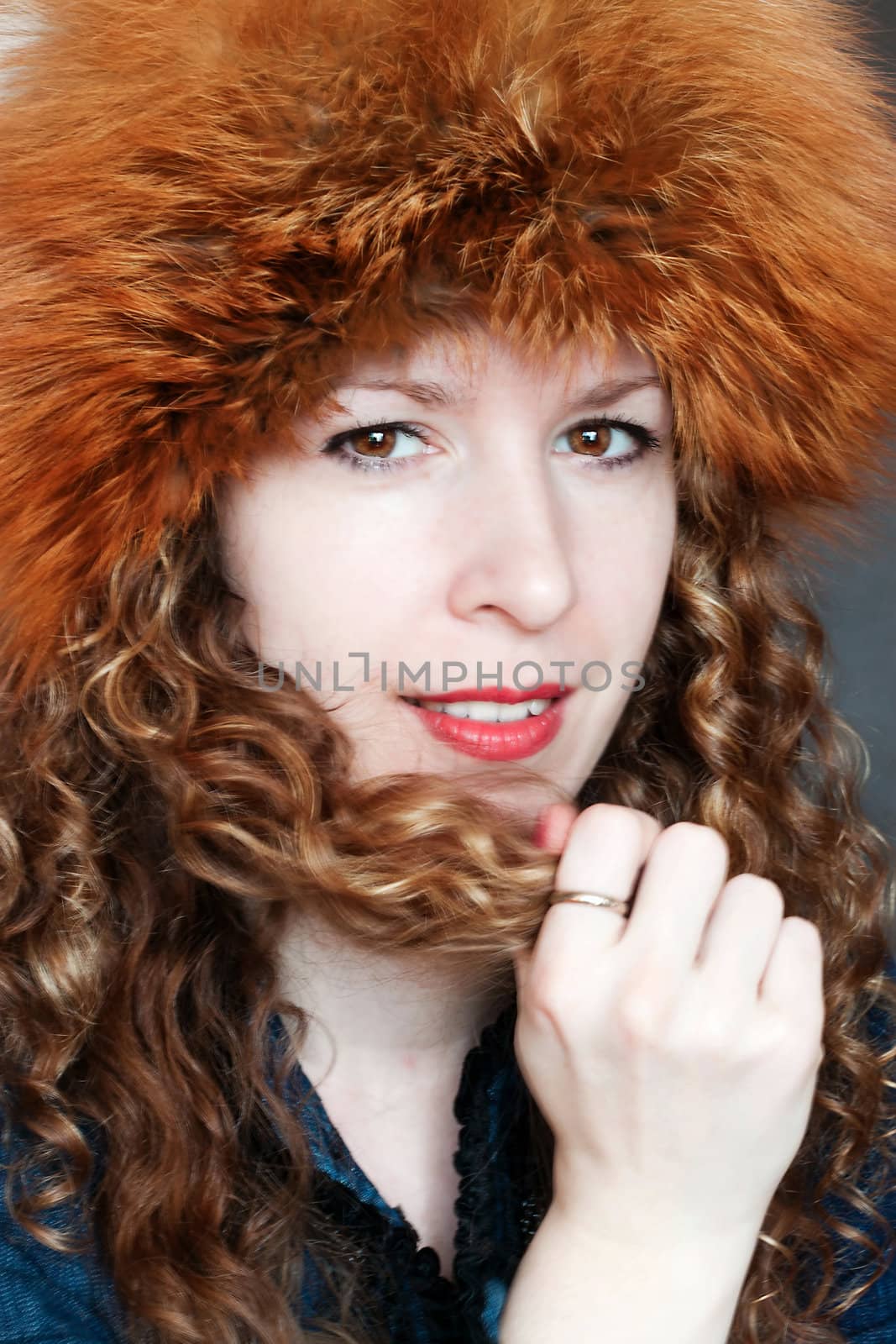 Beautiful young woman posing in big russian style fur hat