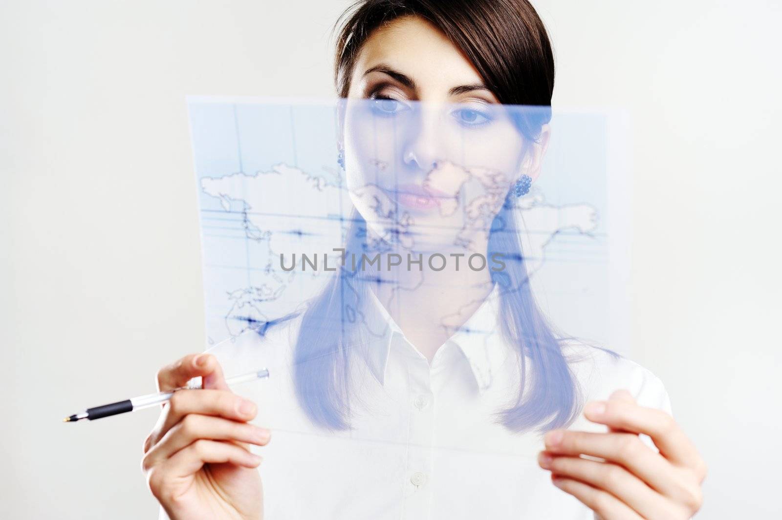 A girl holding a map printed on a transparent material