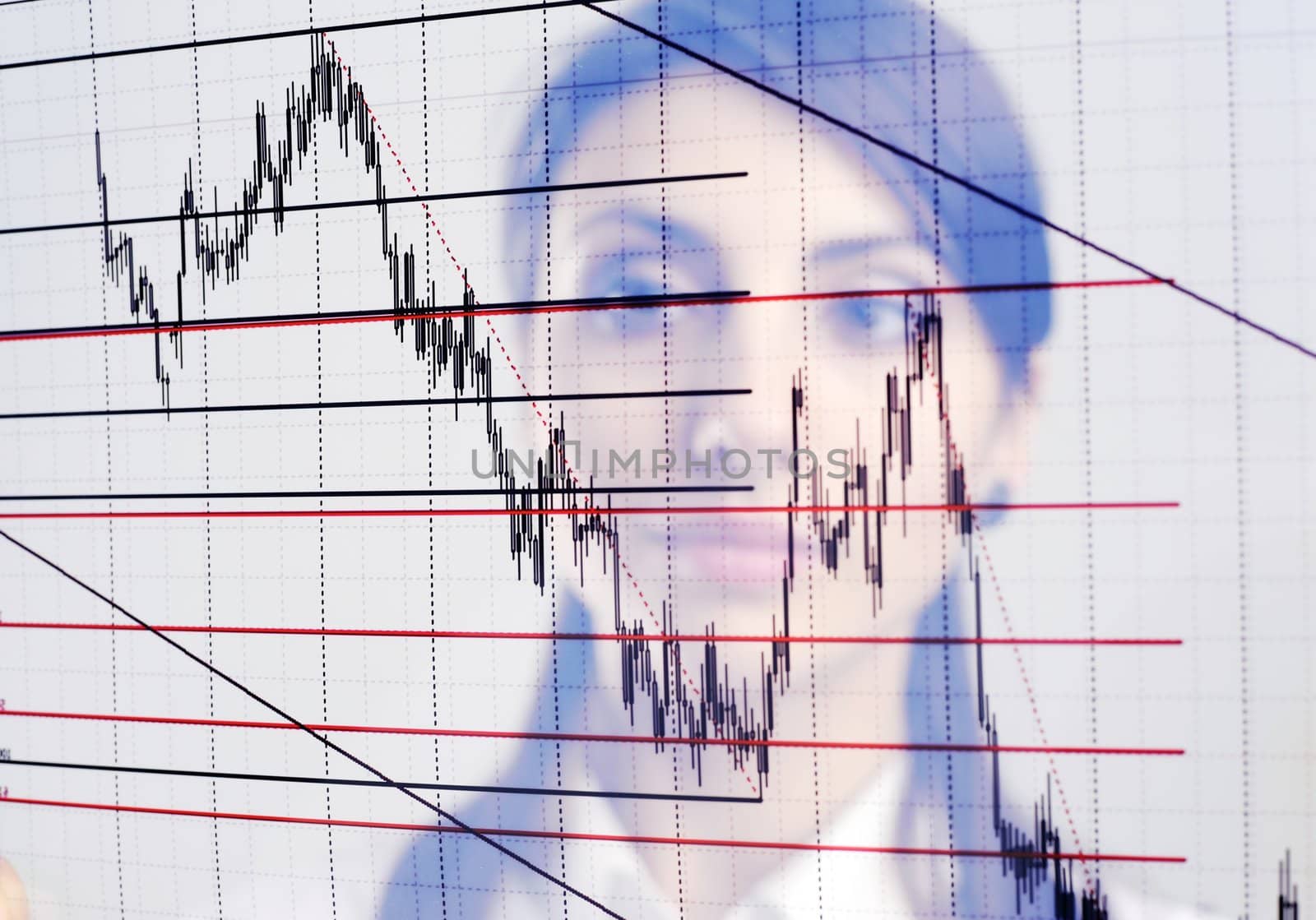 The businesswoman looks at the chart printed on a transparent material