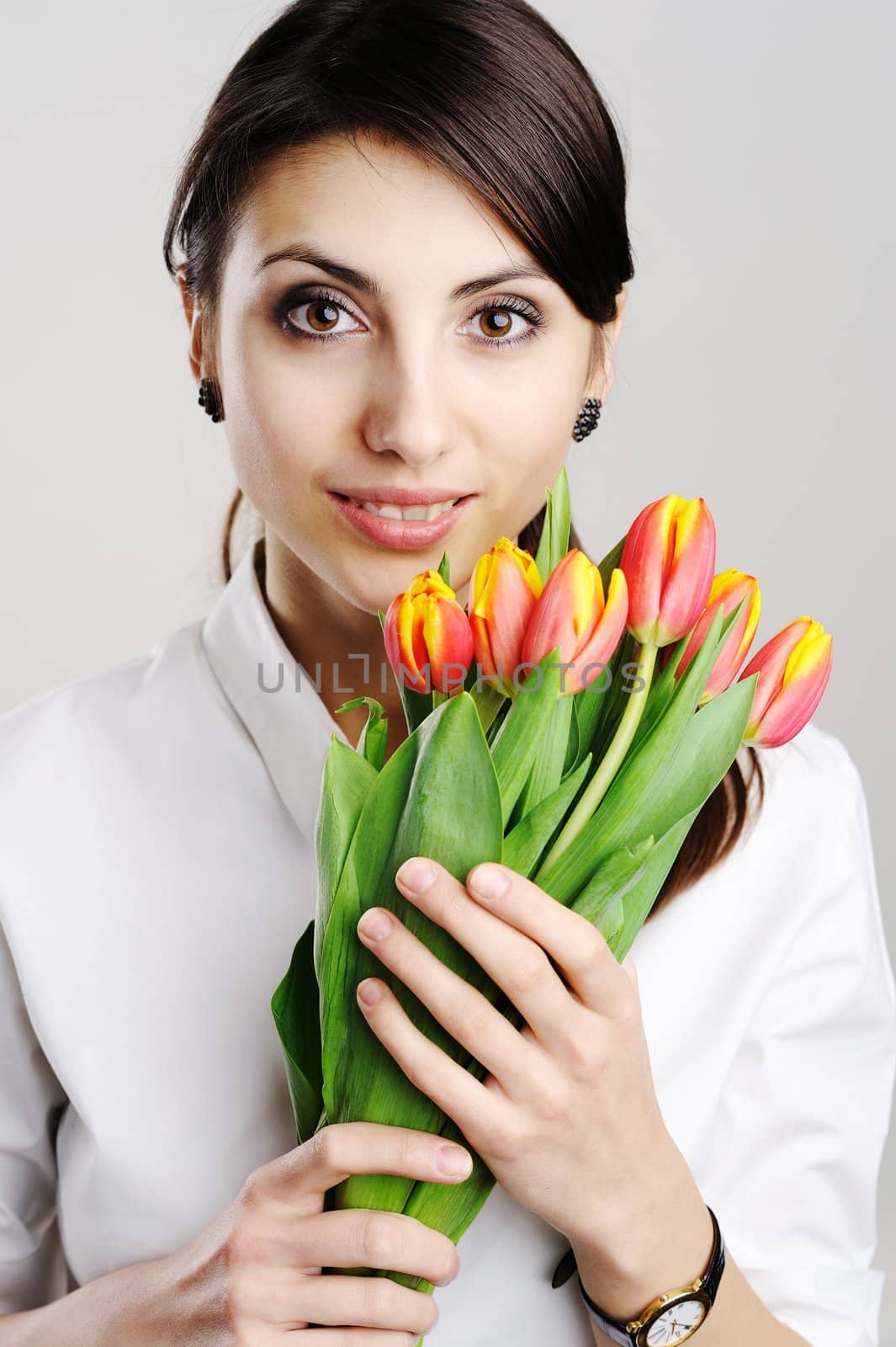 An image of young girl with tulip