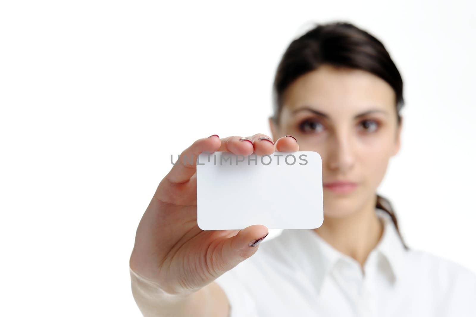 An image of young woman holding blank businesscard in hand. Focus on card 