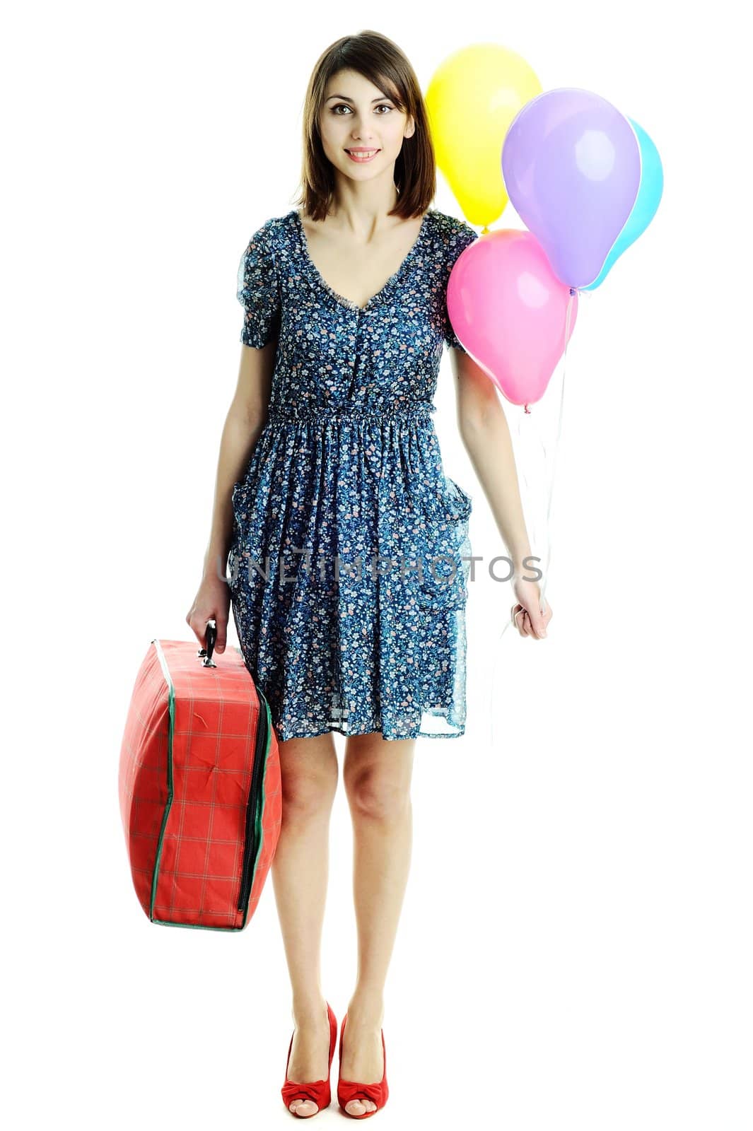 A young beautiful woman with balloons and a bag