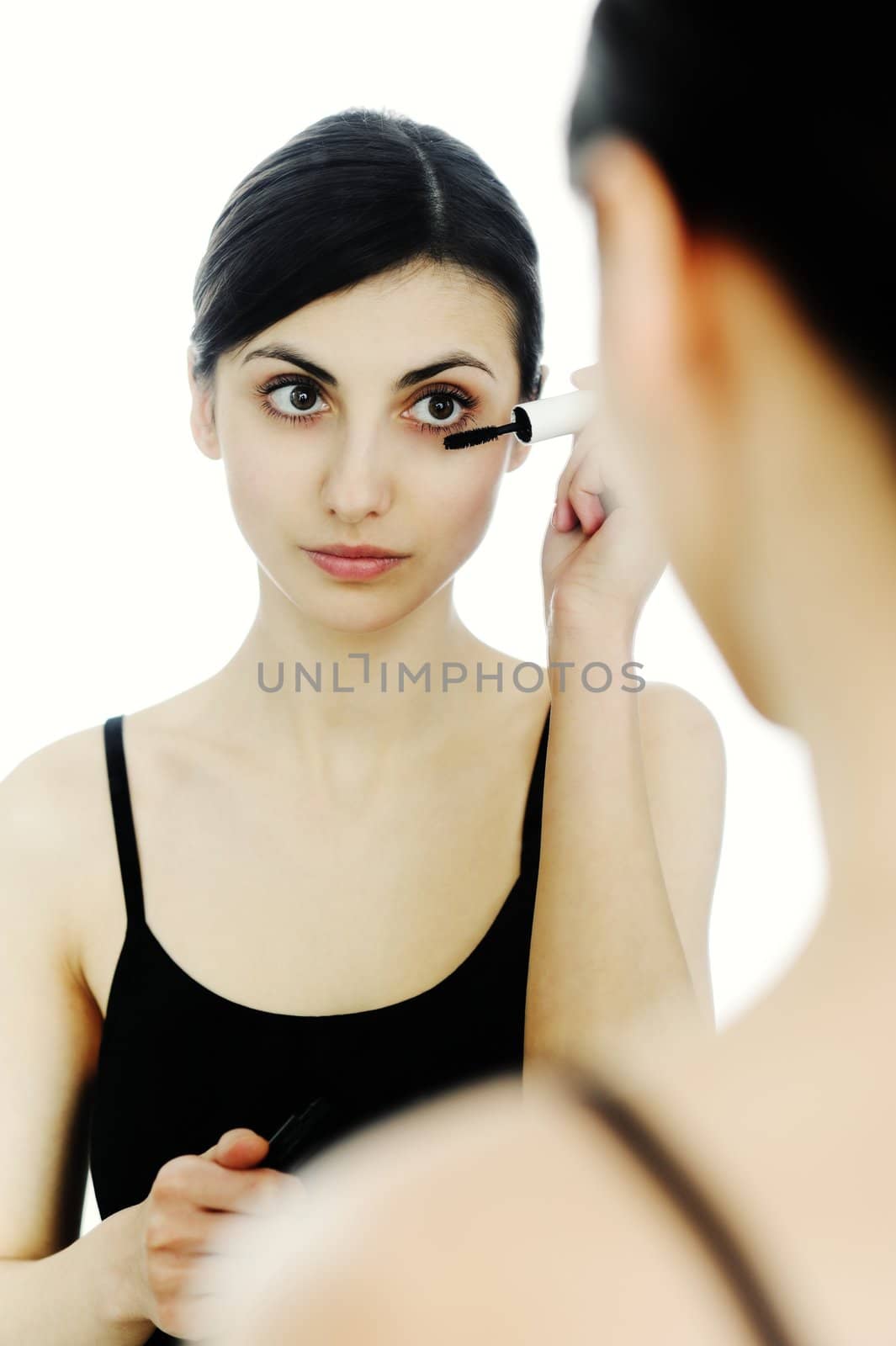 An image of a young woman with mascara