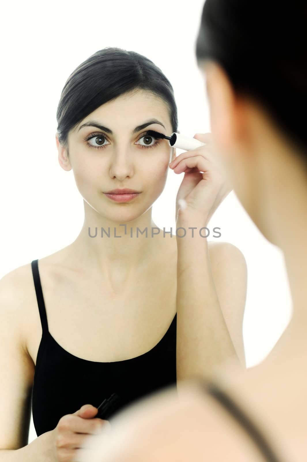 An image of a young woman with mascara