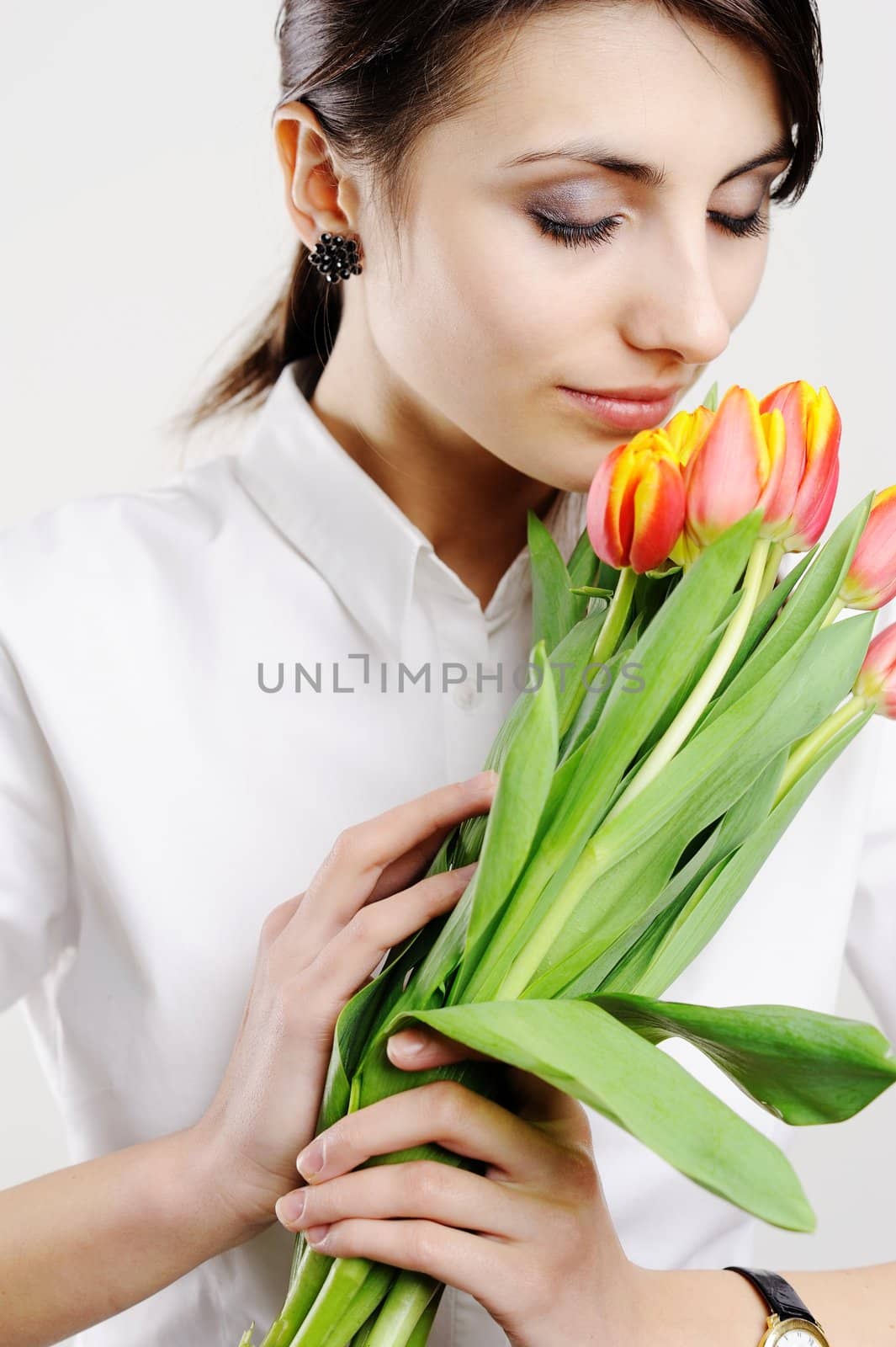 An image of young girl with fresh tulips