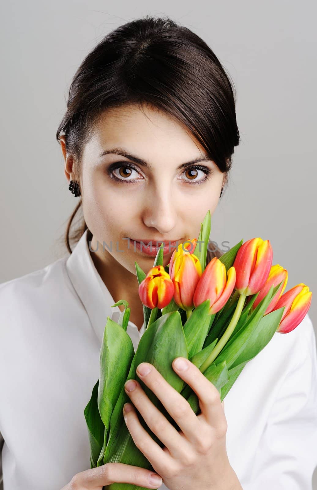 An image of young woman with tulip