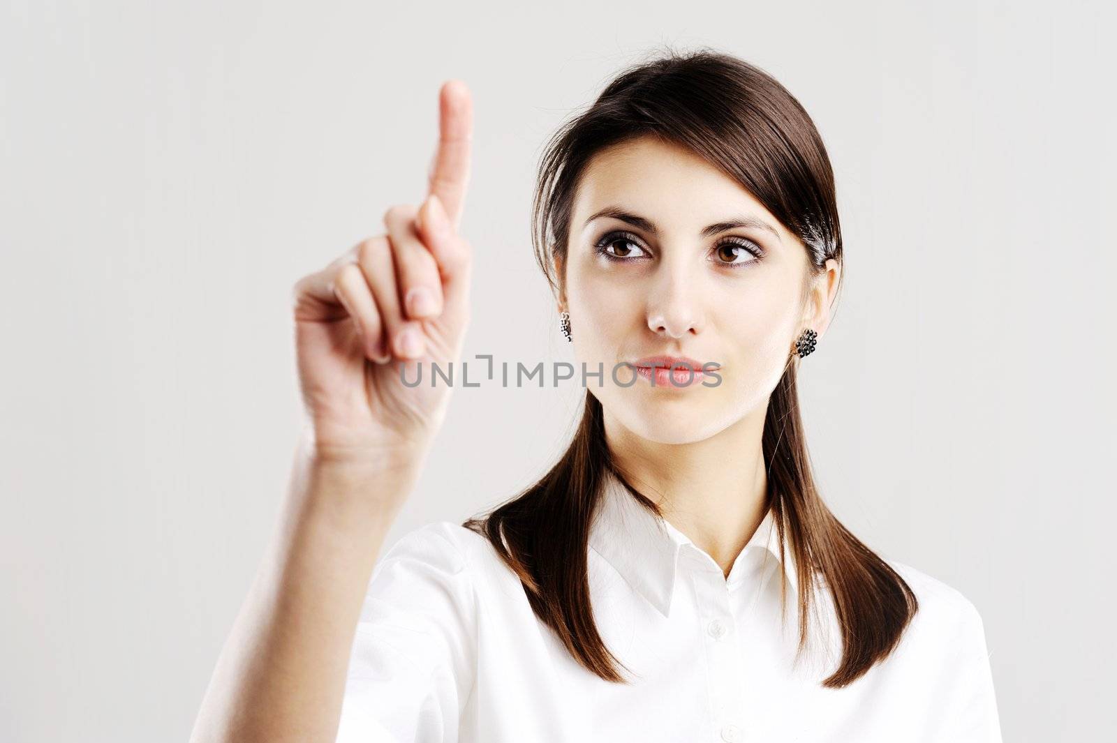 business woman pointing at something on screen