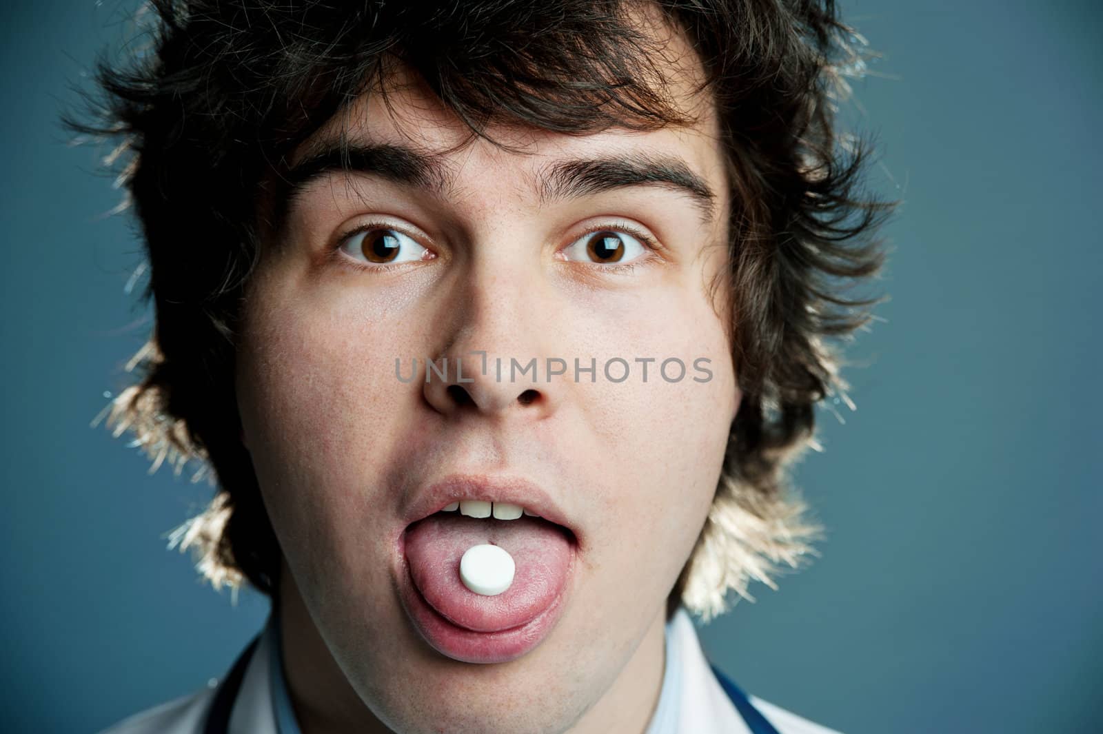 An image of a tablet in the mouth of a man