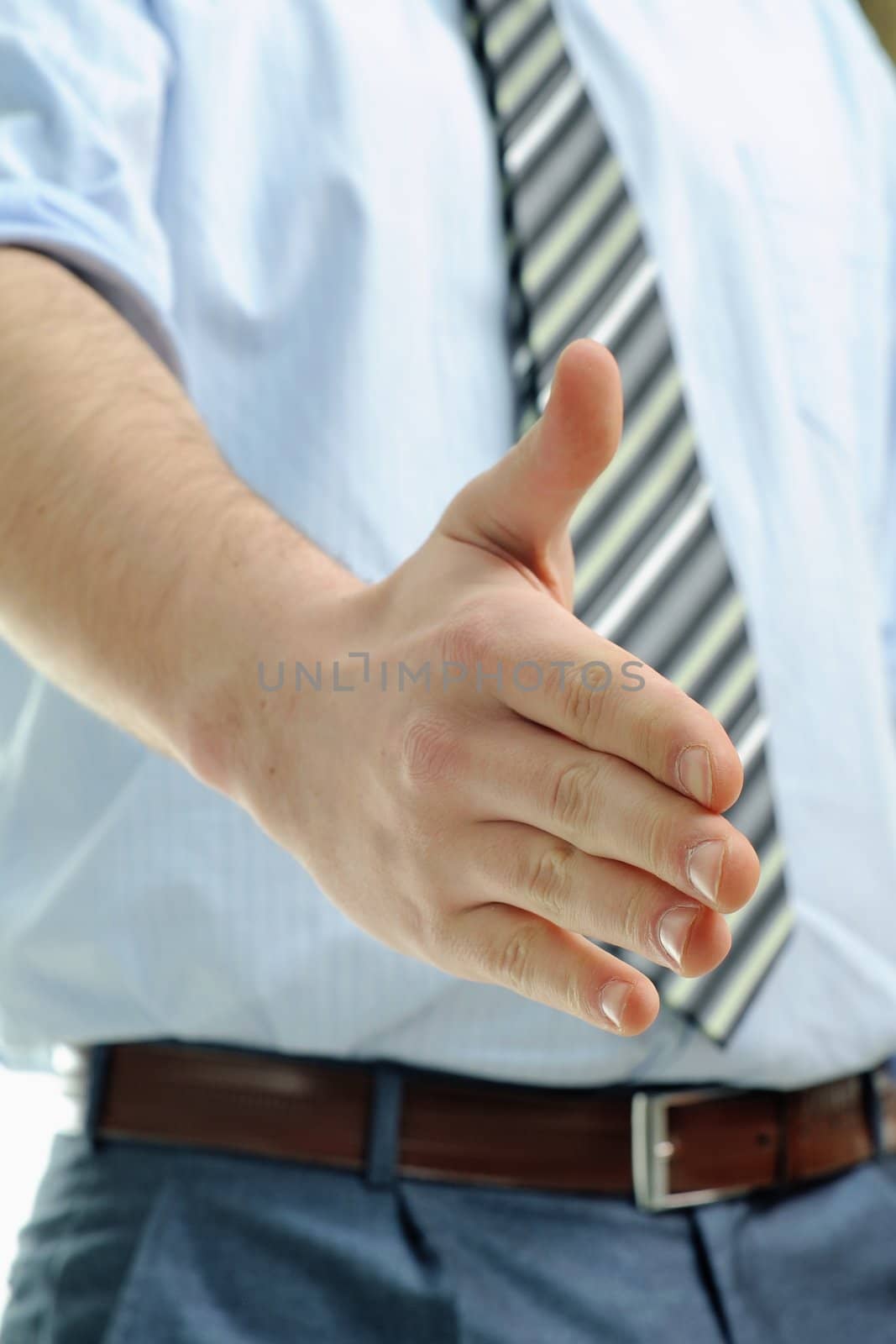 Businessman offering for handshake by velkol