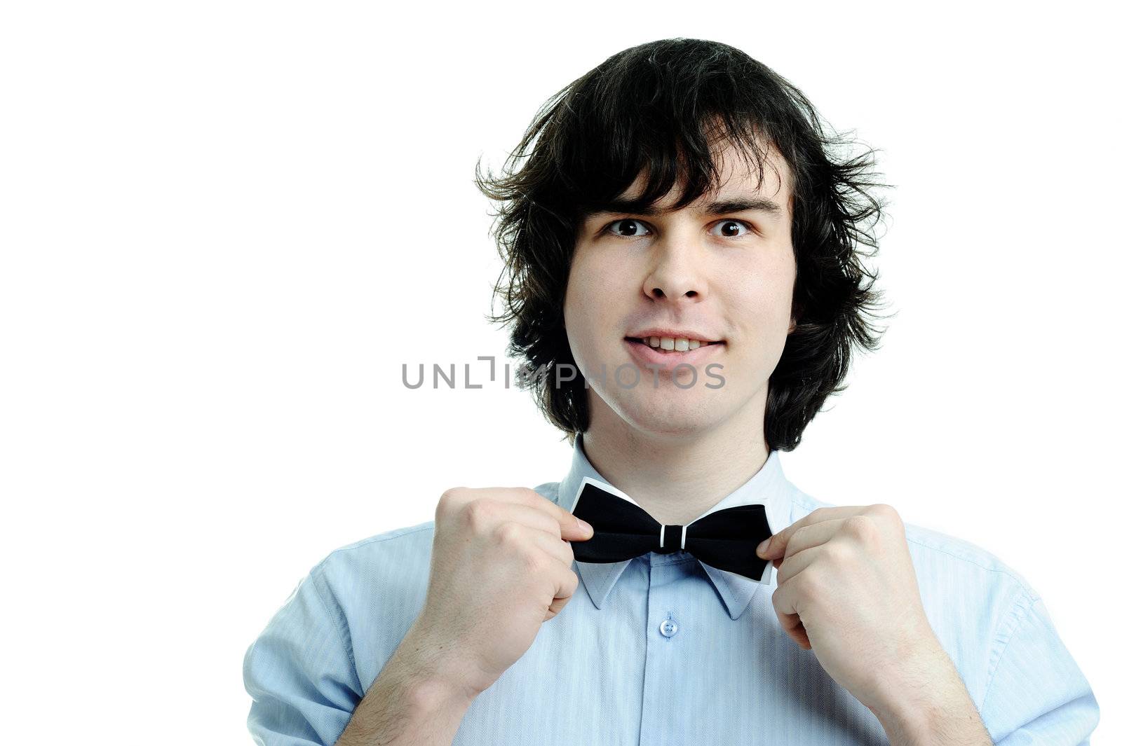 An image of a young waiter touching his tie
