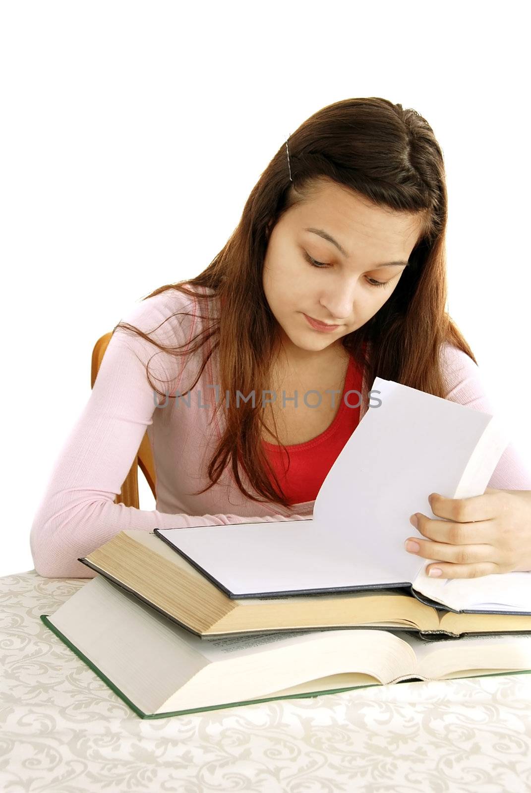 teenage girl portrait with opened books, looking how much she needs to read, learning