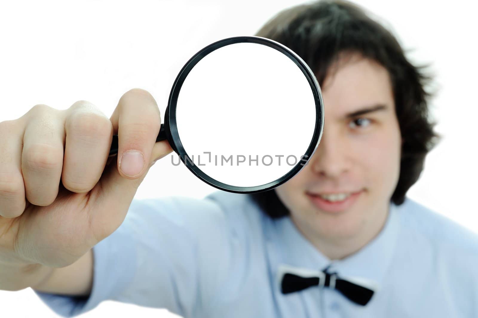 A young man with a magnifying glass in his hand