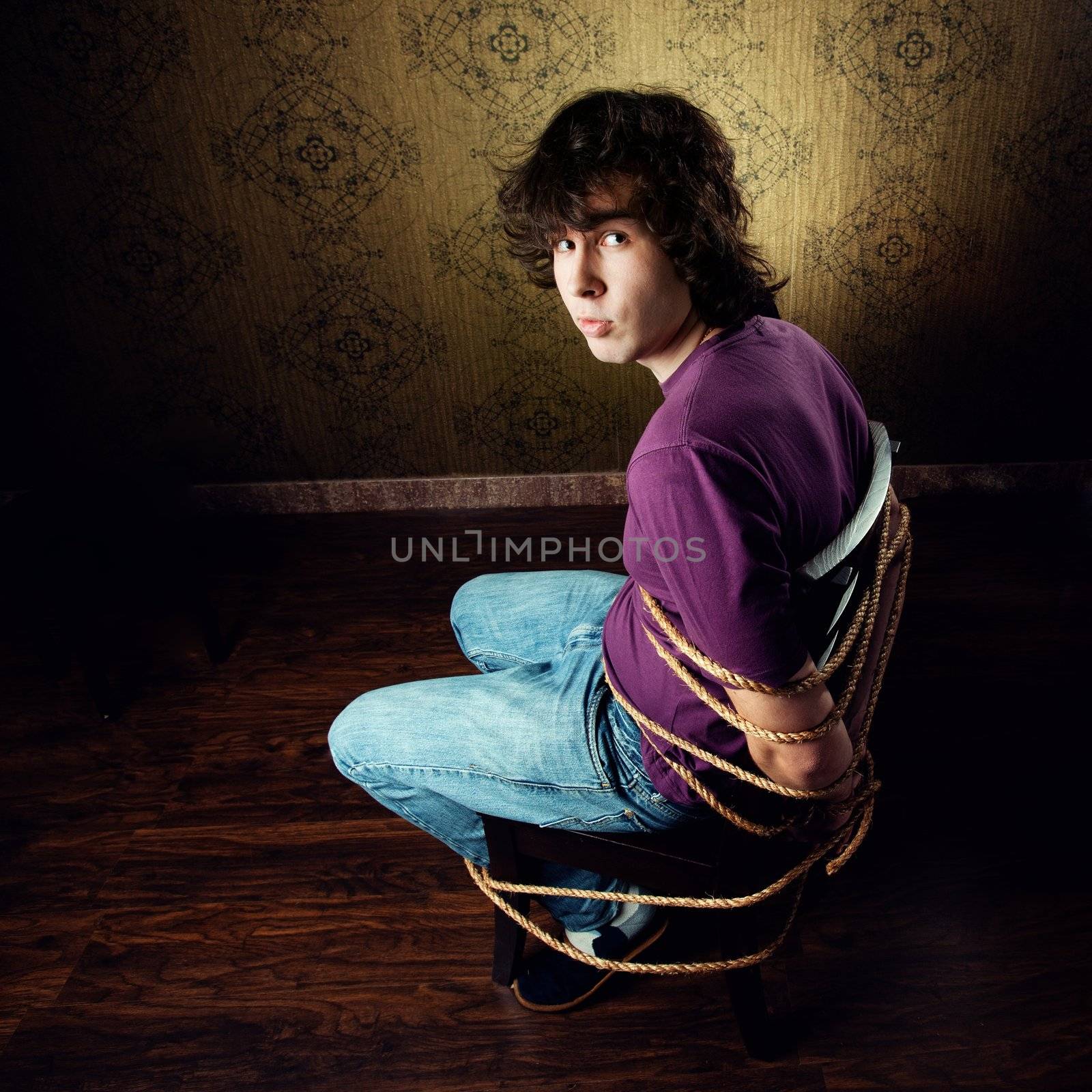 An image of a young man on a chair