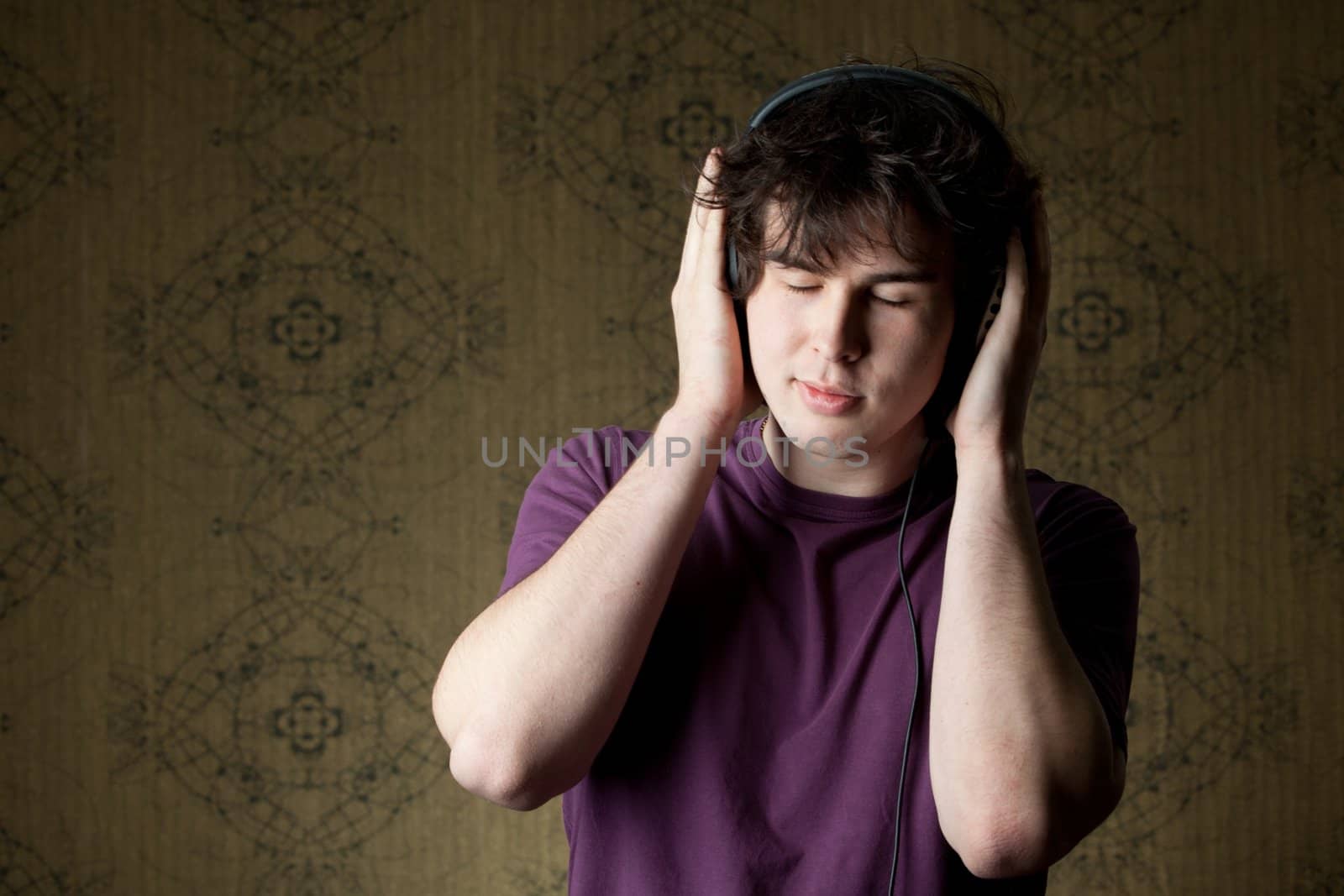 A young man listening to music in headphones