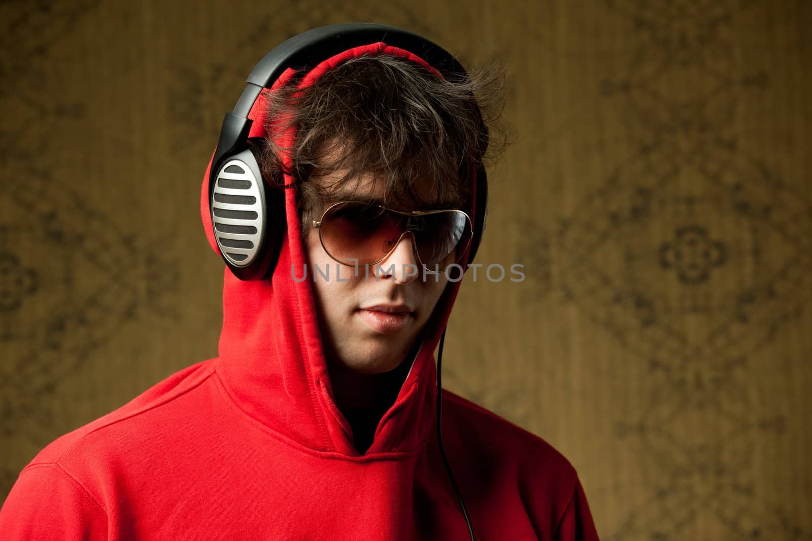 An image of a young man listening to music in headphones