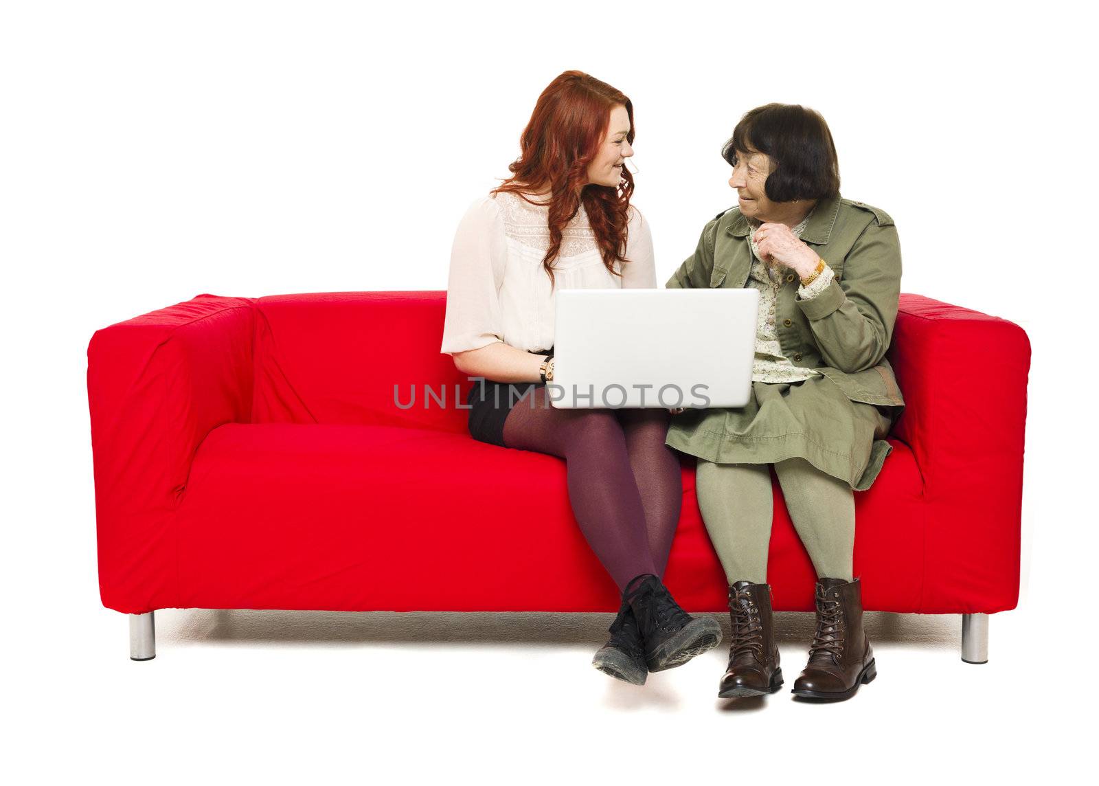Grandmother and Grandchild in a sofa with computer