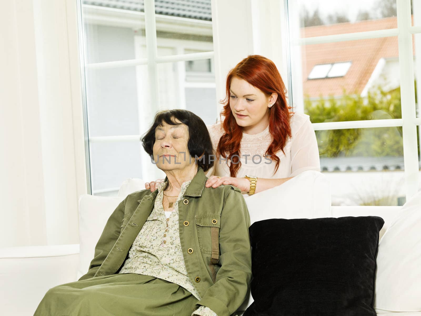 Young woman giving massage to her Grandmother