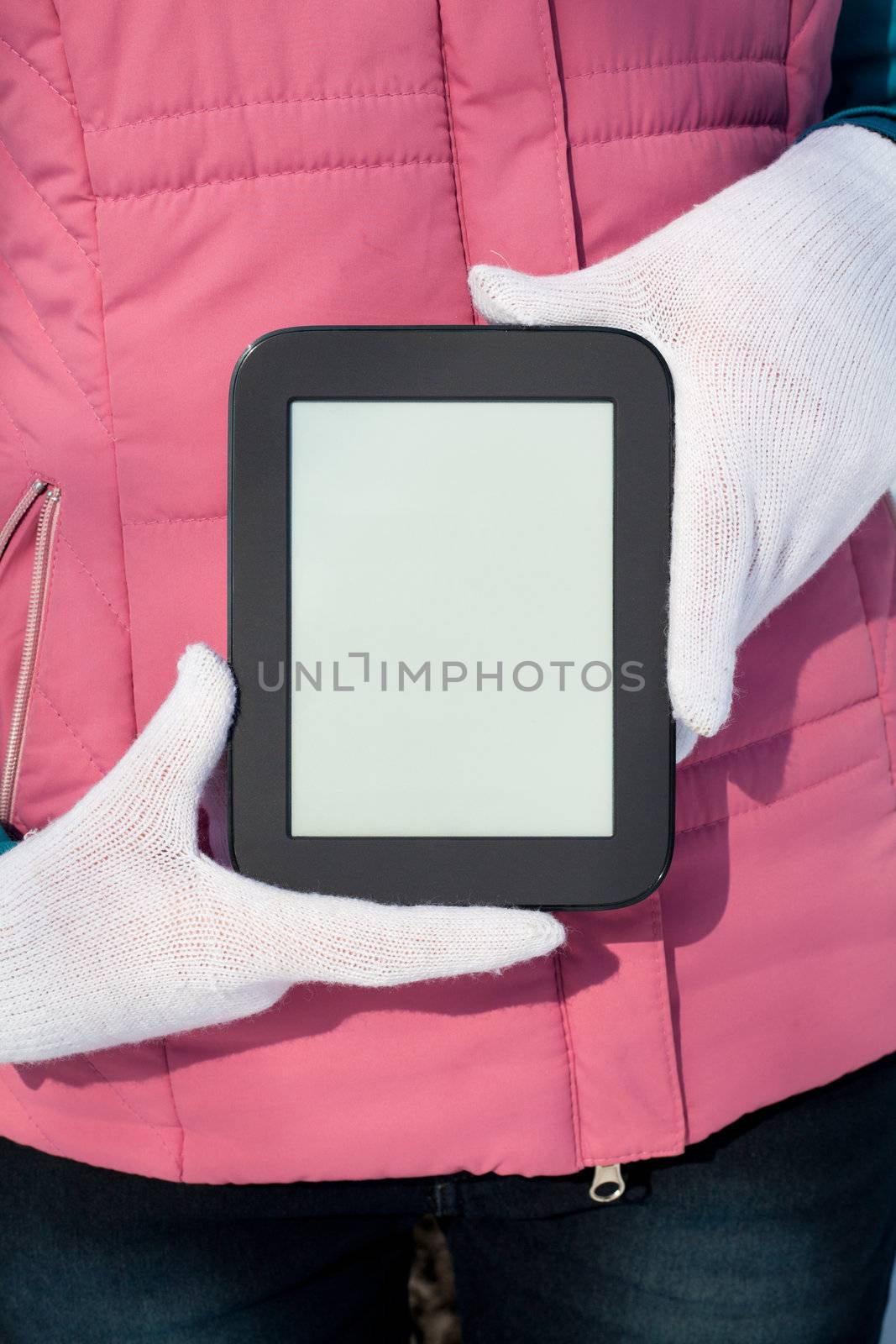 Woman's hands holding e-book reader by AndreyKr