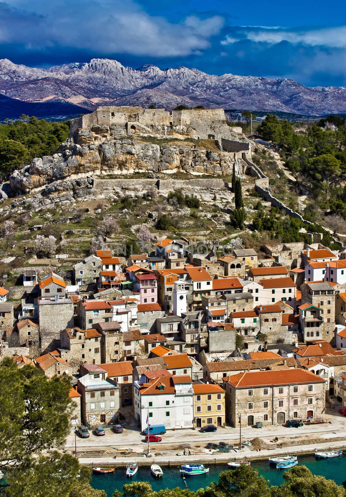 Novigrad dalmatinski with fortress, and Velebit mountain in back