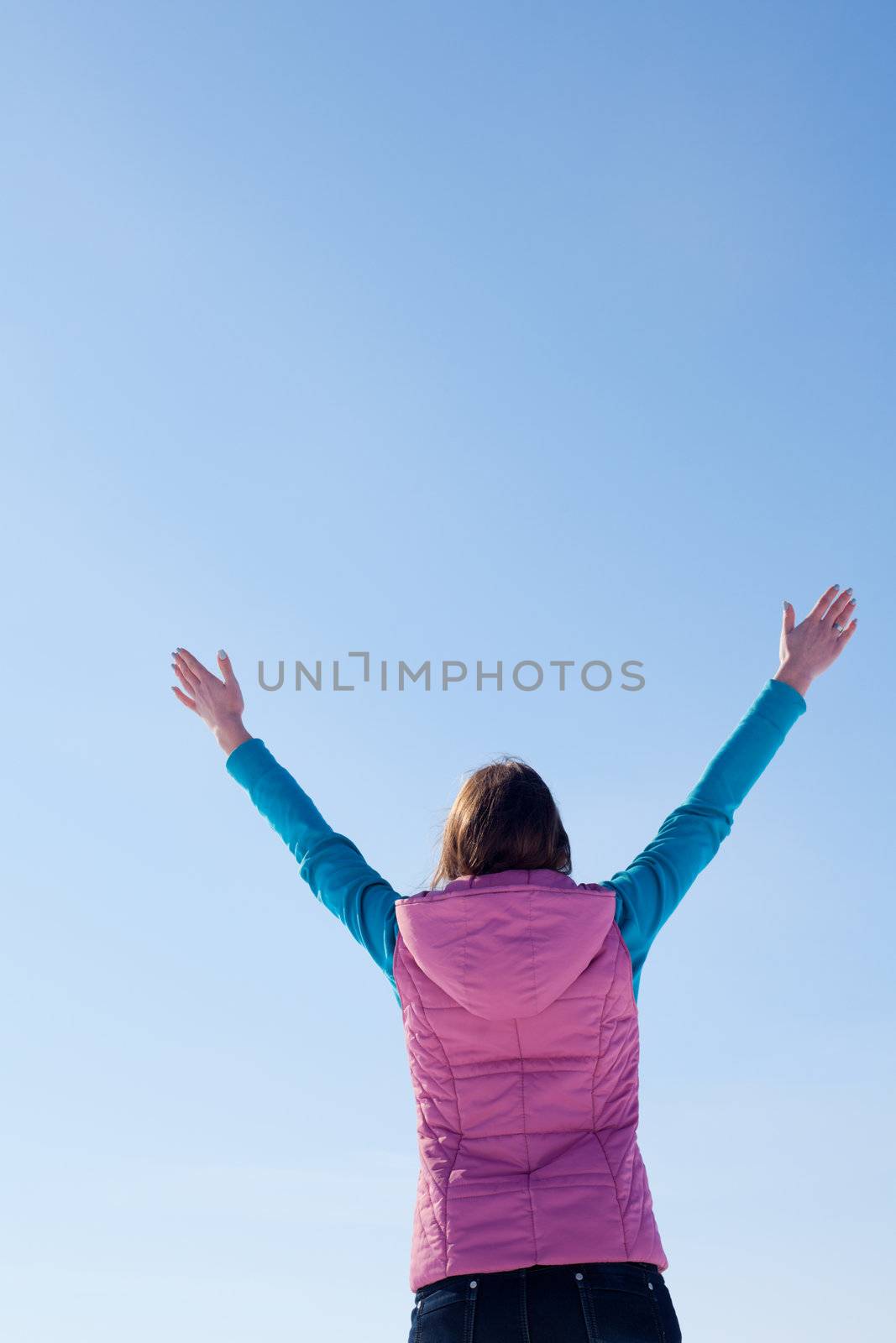 Teen girl staying with raised hands by AndreyKr