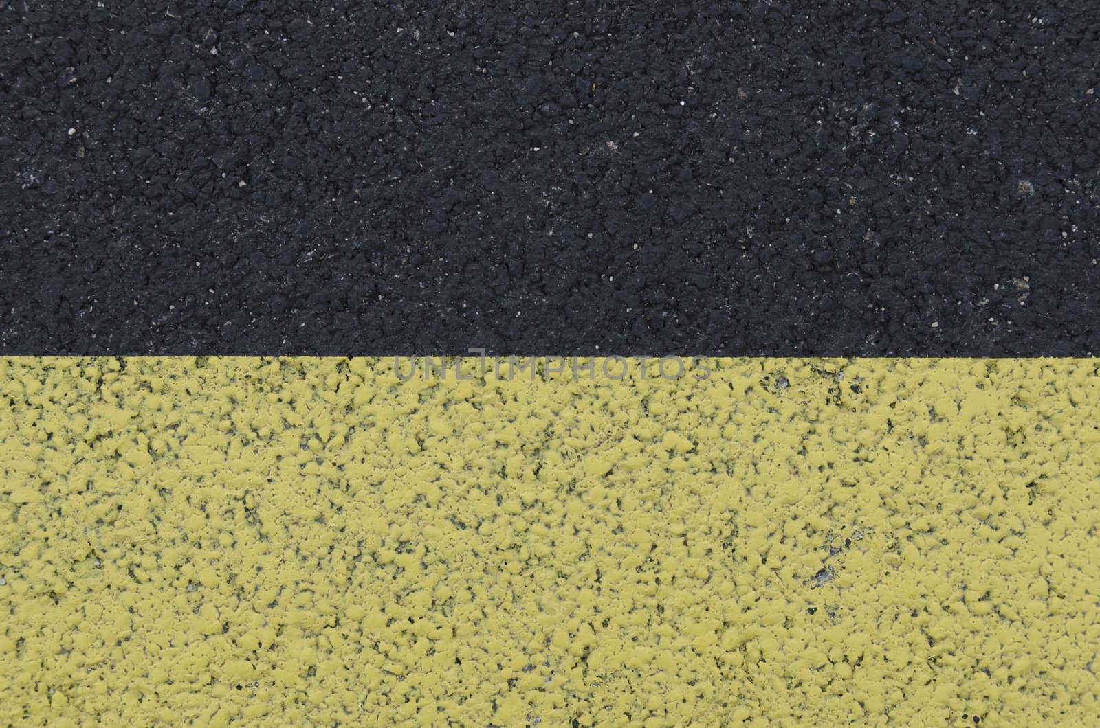 yellow marking on asphalt, textured background