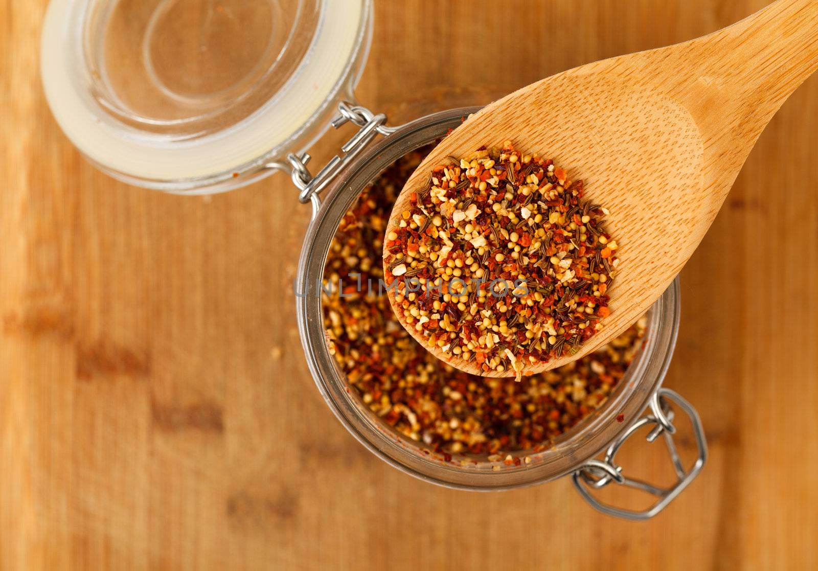 mixture spice in a wooden spoon, closeup