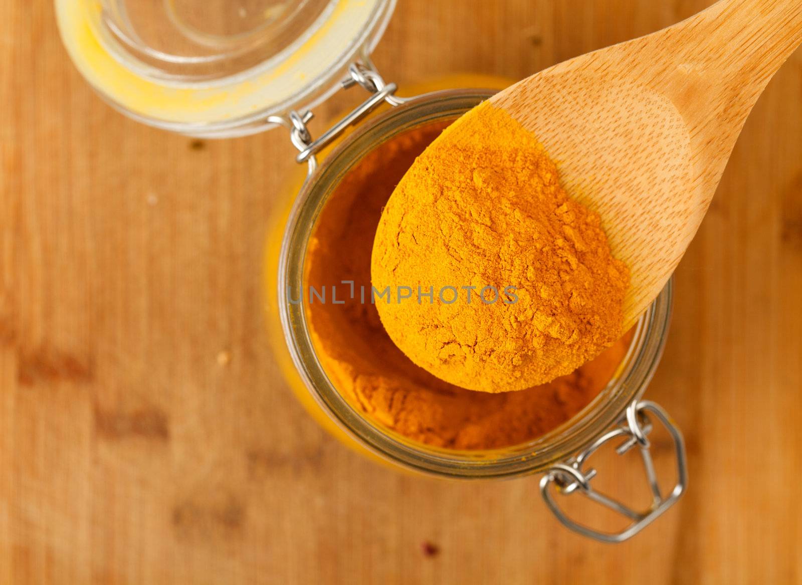 spice saffron in a wooden spoon, closeup
