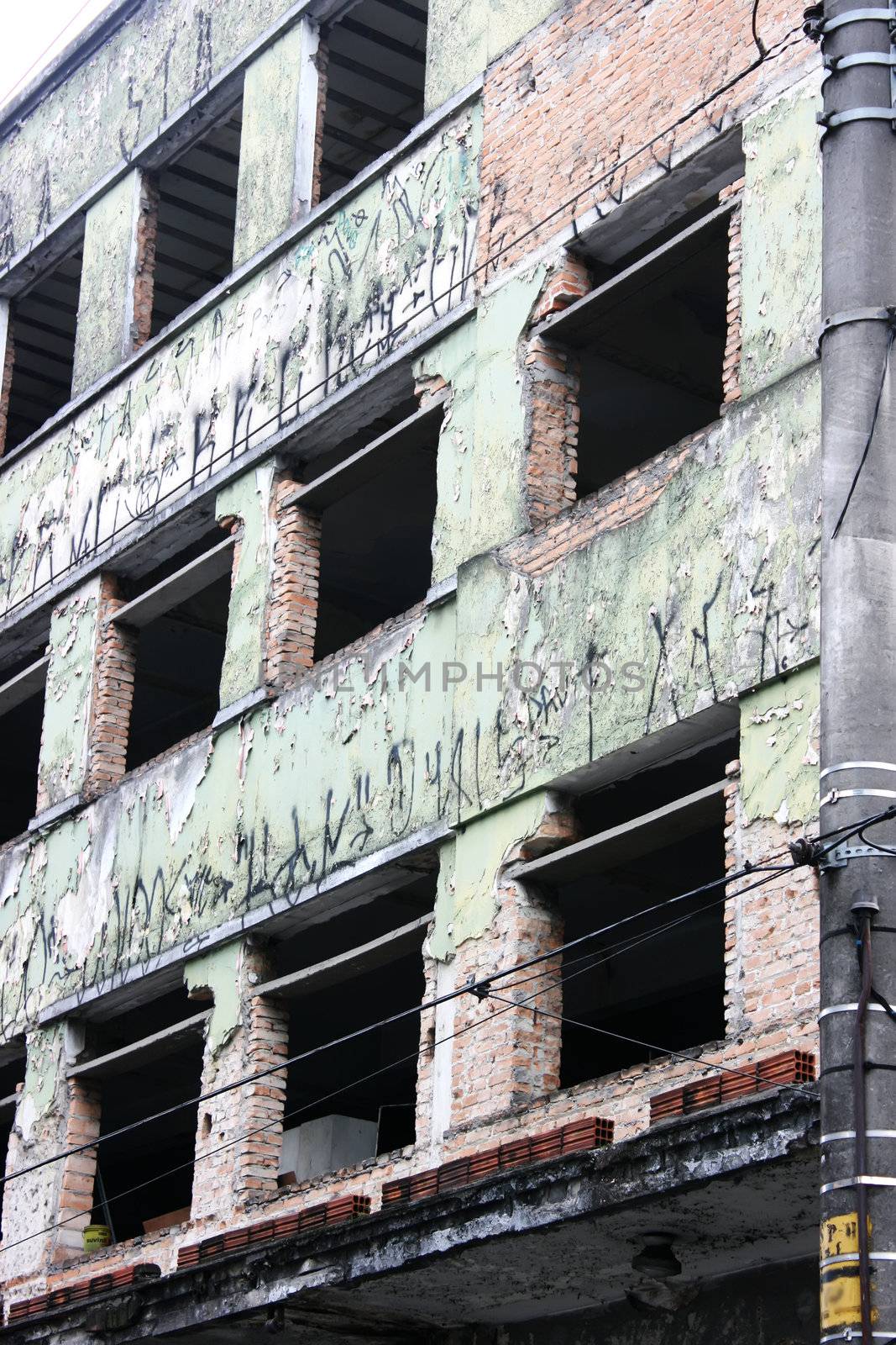 Abandoned building in downtown Sao Paulo. The wall is covered with street gang symbols.