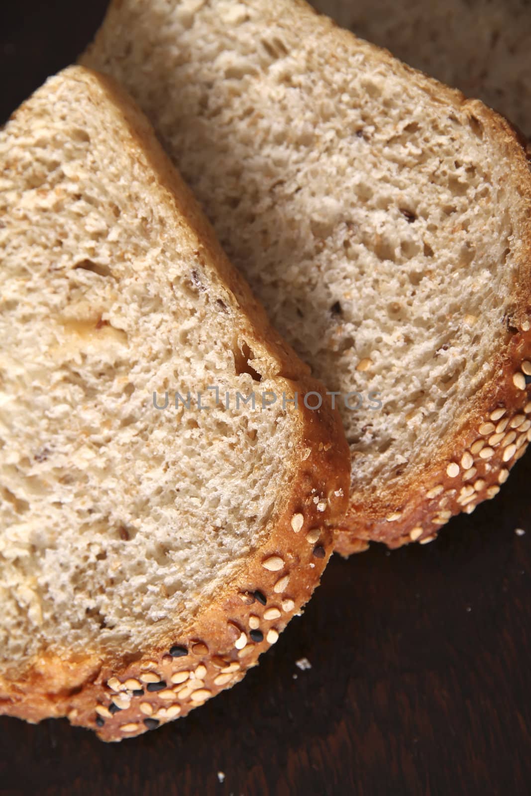 Close up of three slices of bread. Natural wood background.