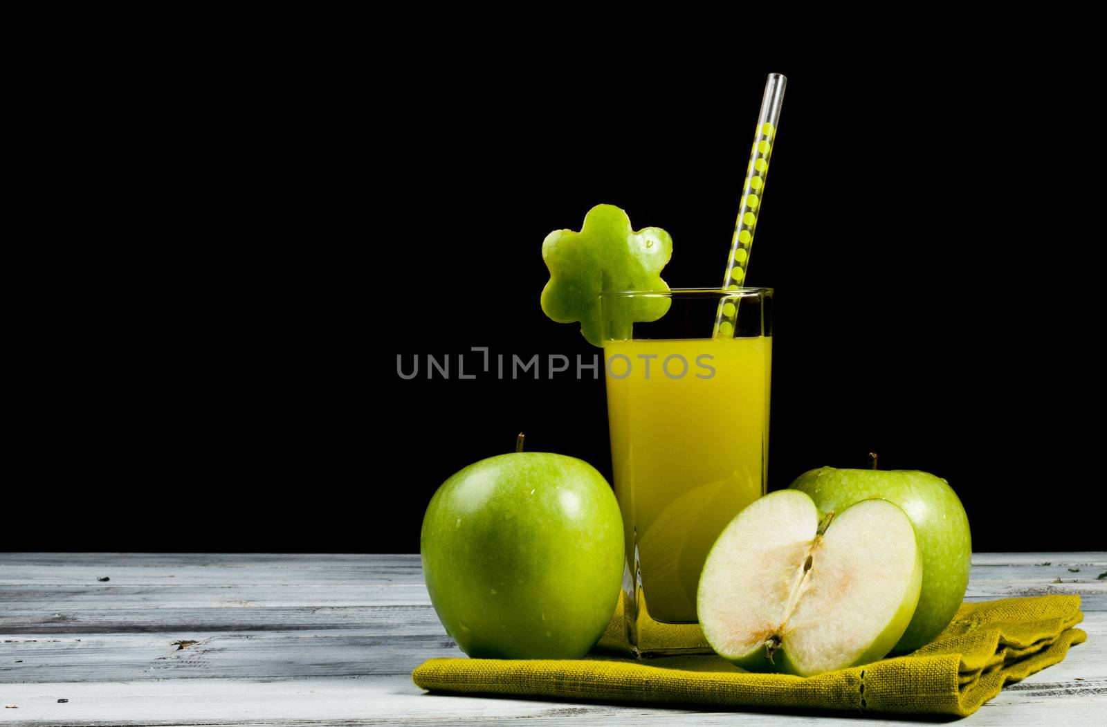 a glass of fresh and cold green apple juice 