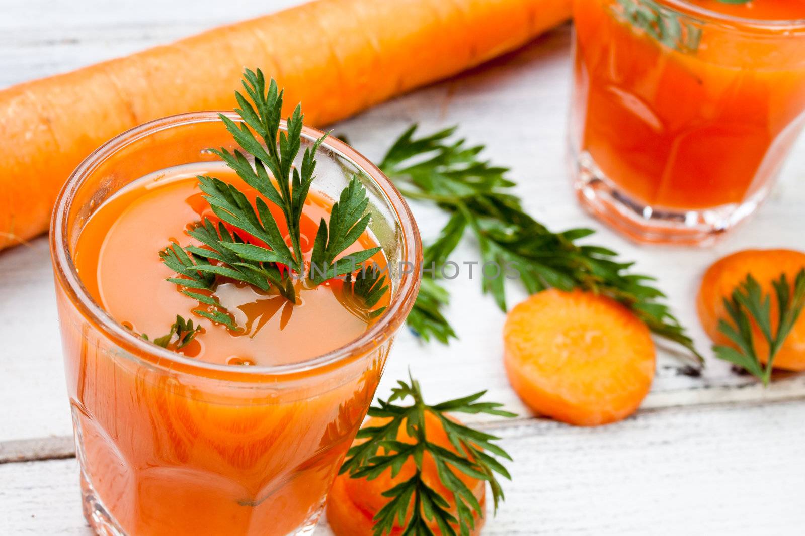 glasses of fresh and cold carrot juice
