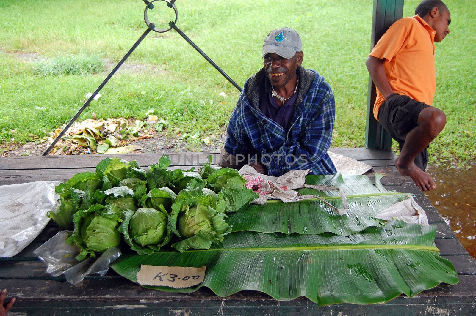 Man saling cabbage on market by danemo