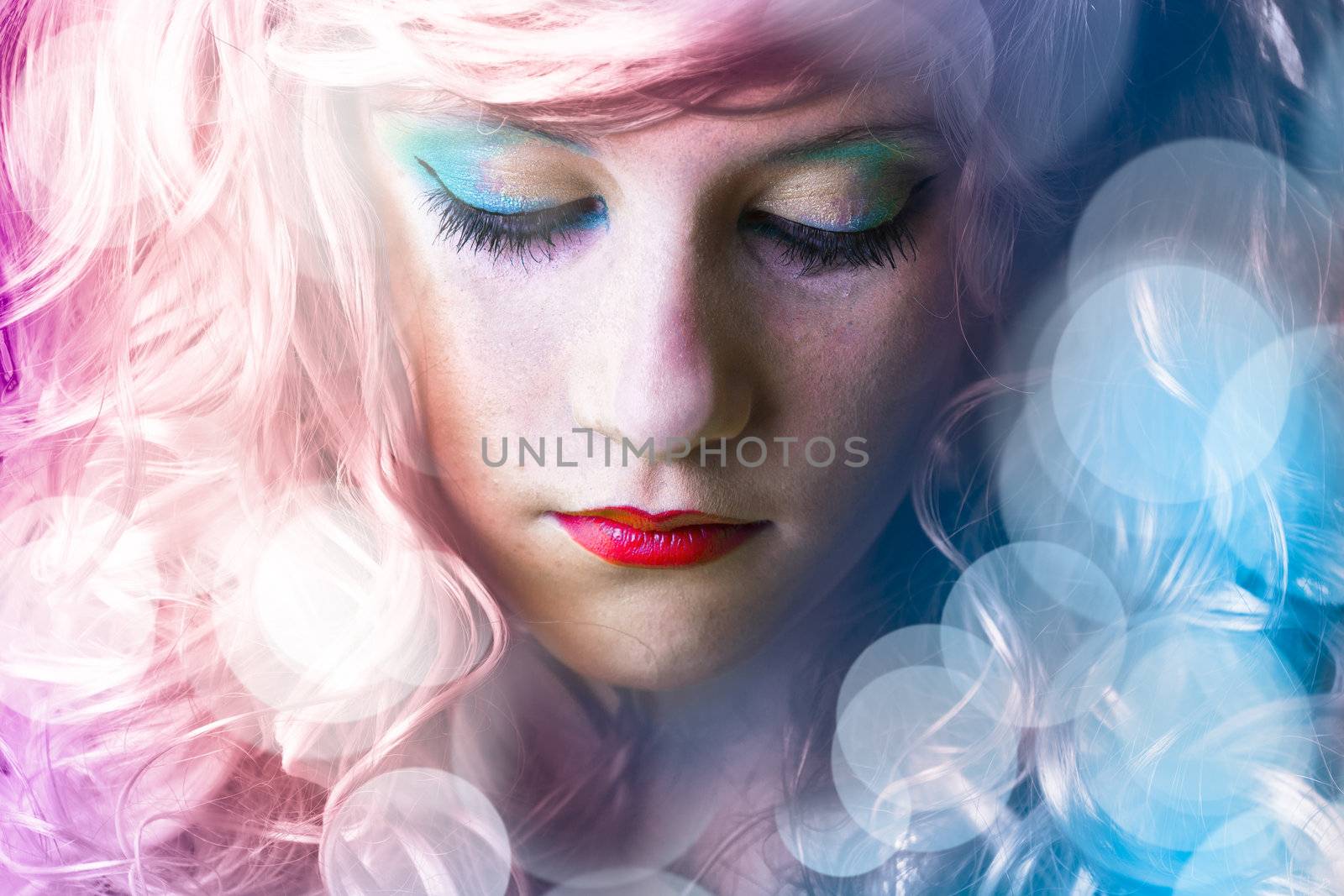 Teen with colored hair, light effects in disco