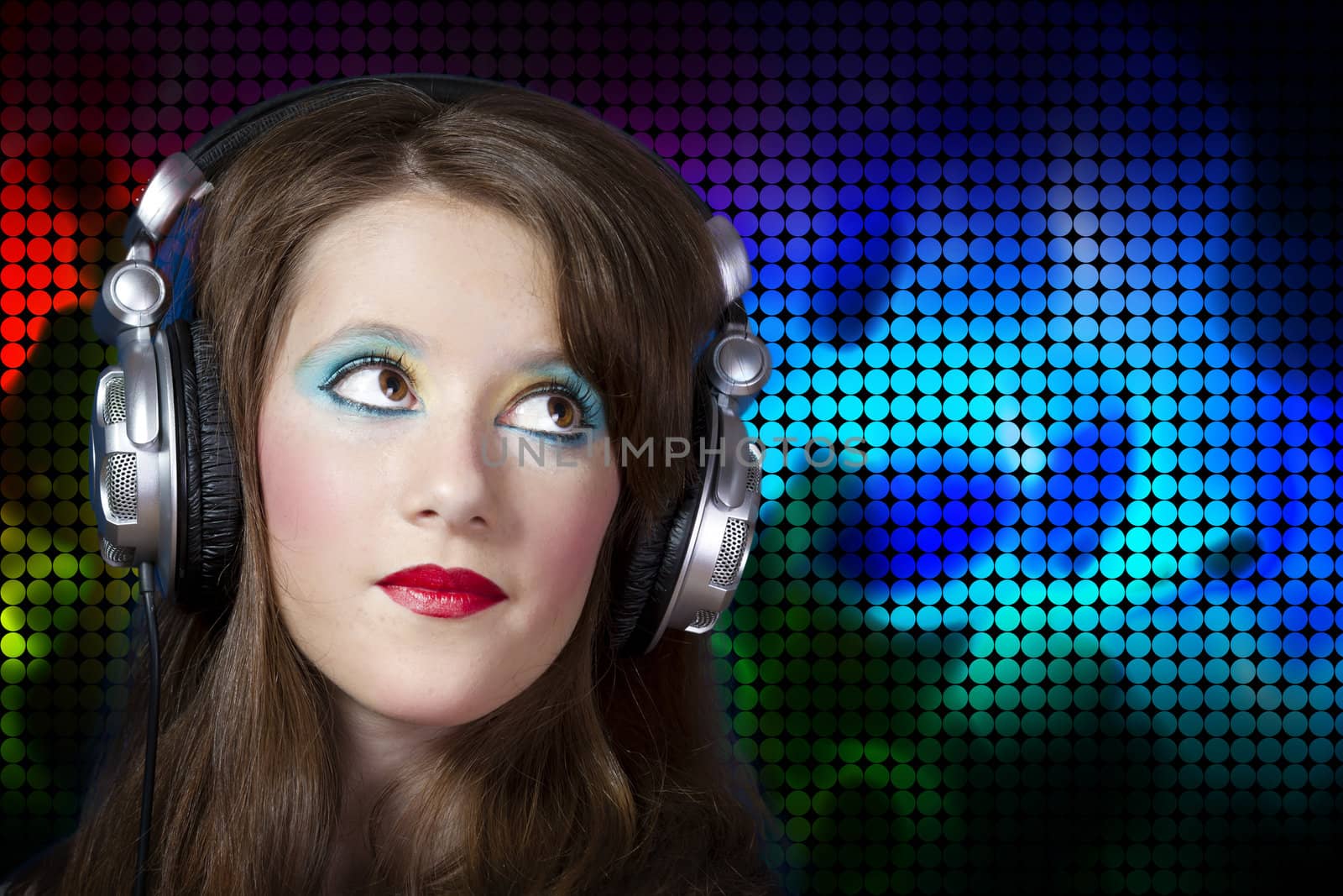 Beautiful Girl listening music over colored dots